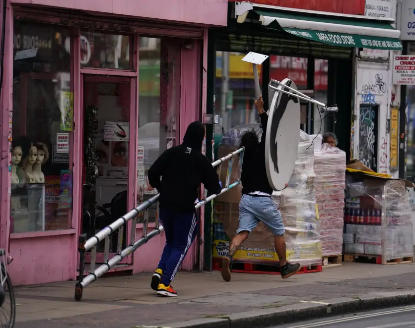 Two blokes were seen legging it with the satellite dish which was emblazoned with a howling wolf. (PA)