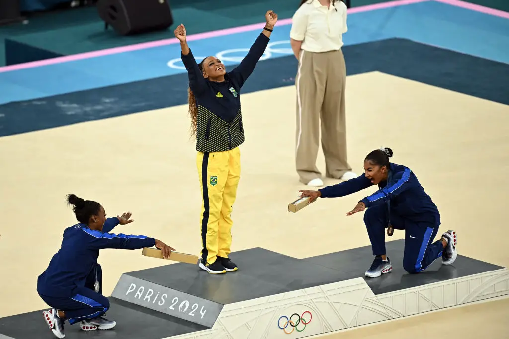 Biles and Chiles created an iconic photo with Andrade on the podium following the Gymnastics Floor event. (PAUL ELLIS/AFP via Getty Images)