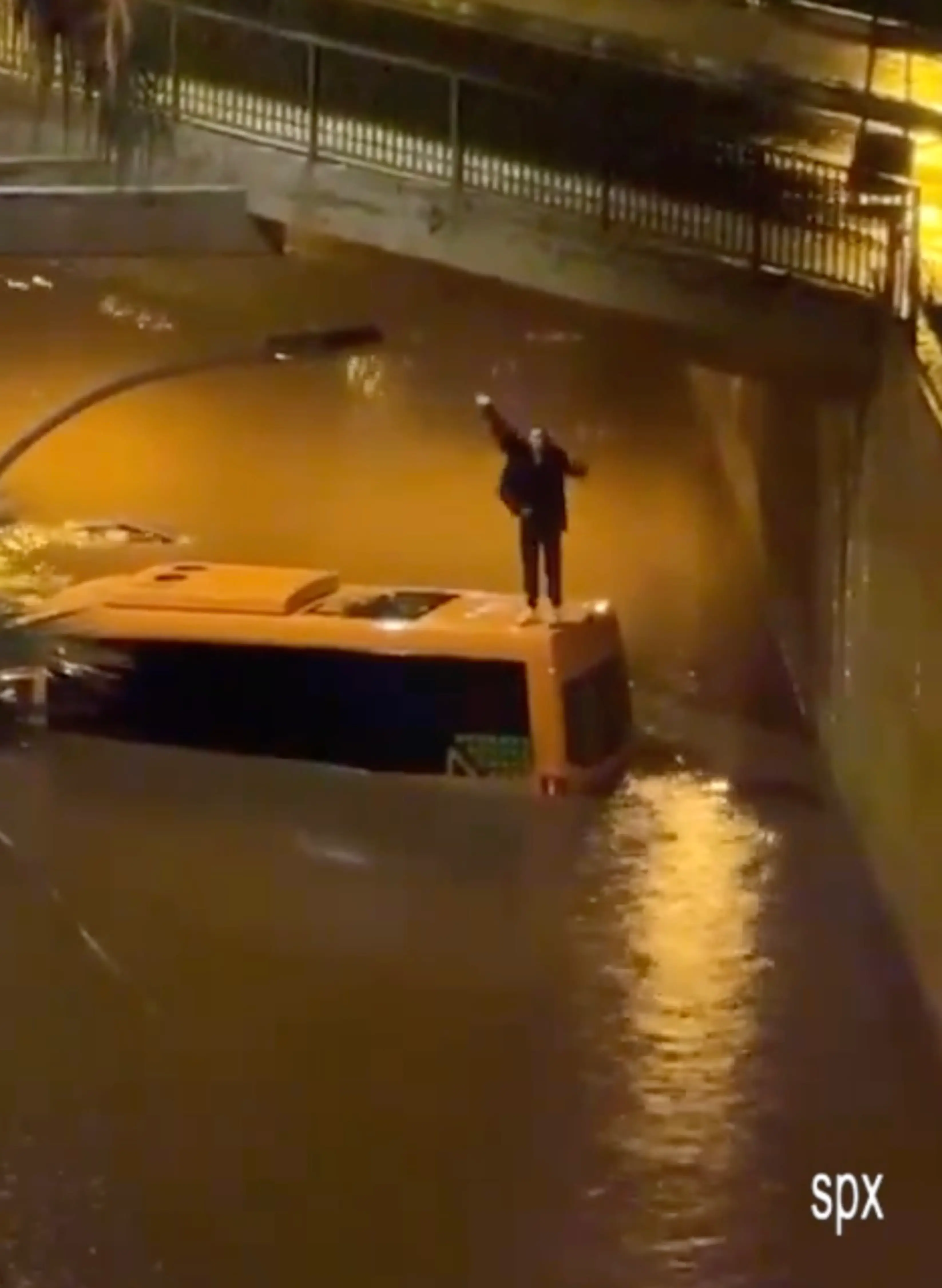 One of the tourists was seen on top of the drowning minibus waving for help (SOLARPIX)