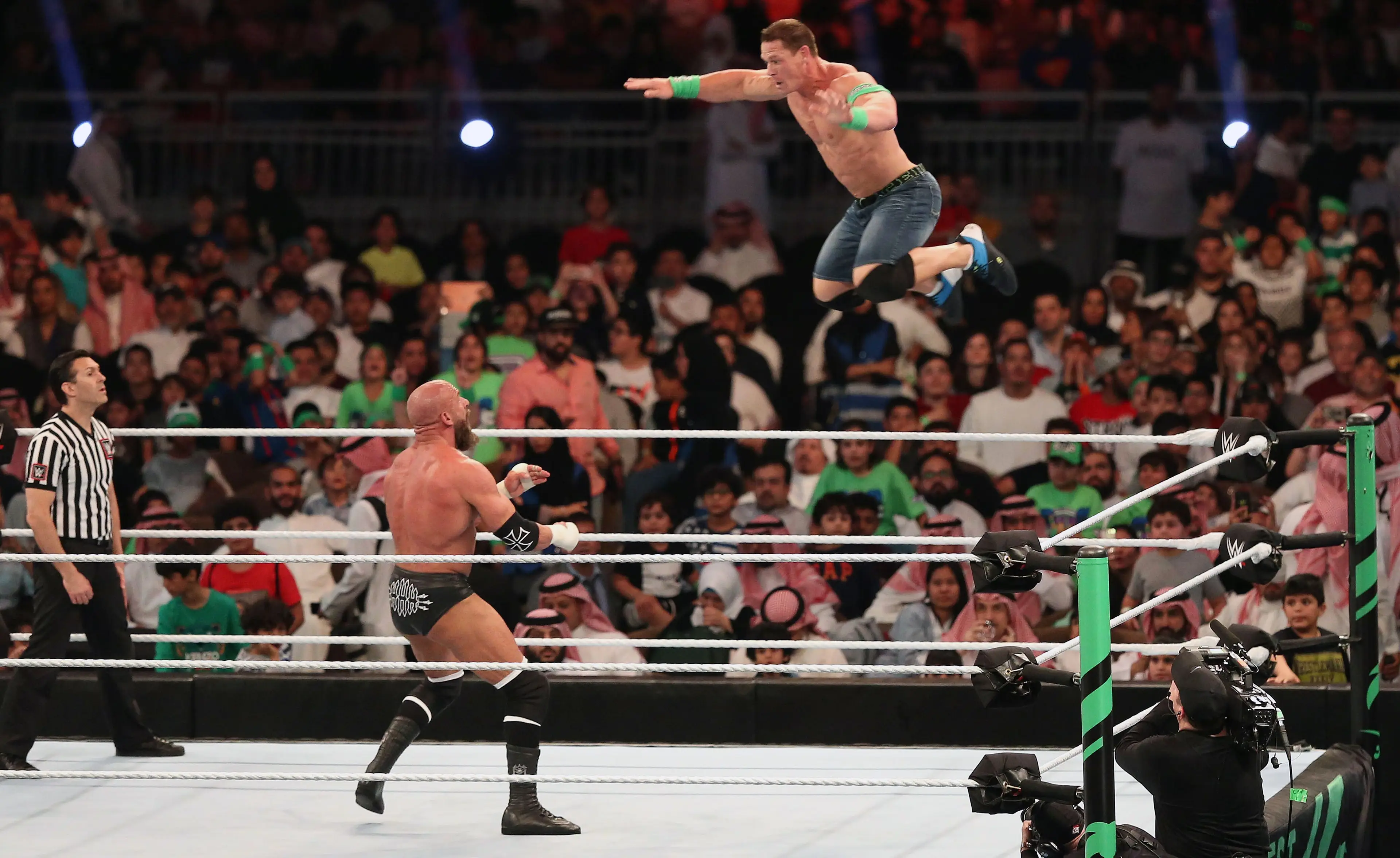 Cena taking on Triple H during his prime wrestling days (STRINGER/AFP via Getty Images)