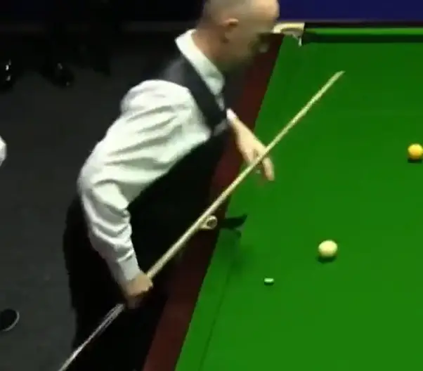 His chalk fell out of his pocket and the cue ball rolled right over it.