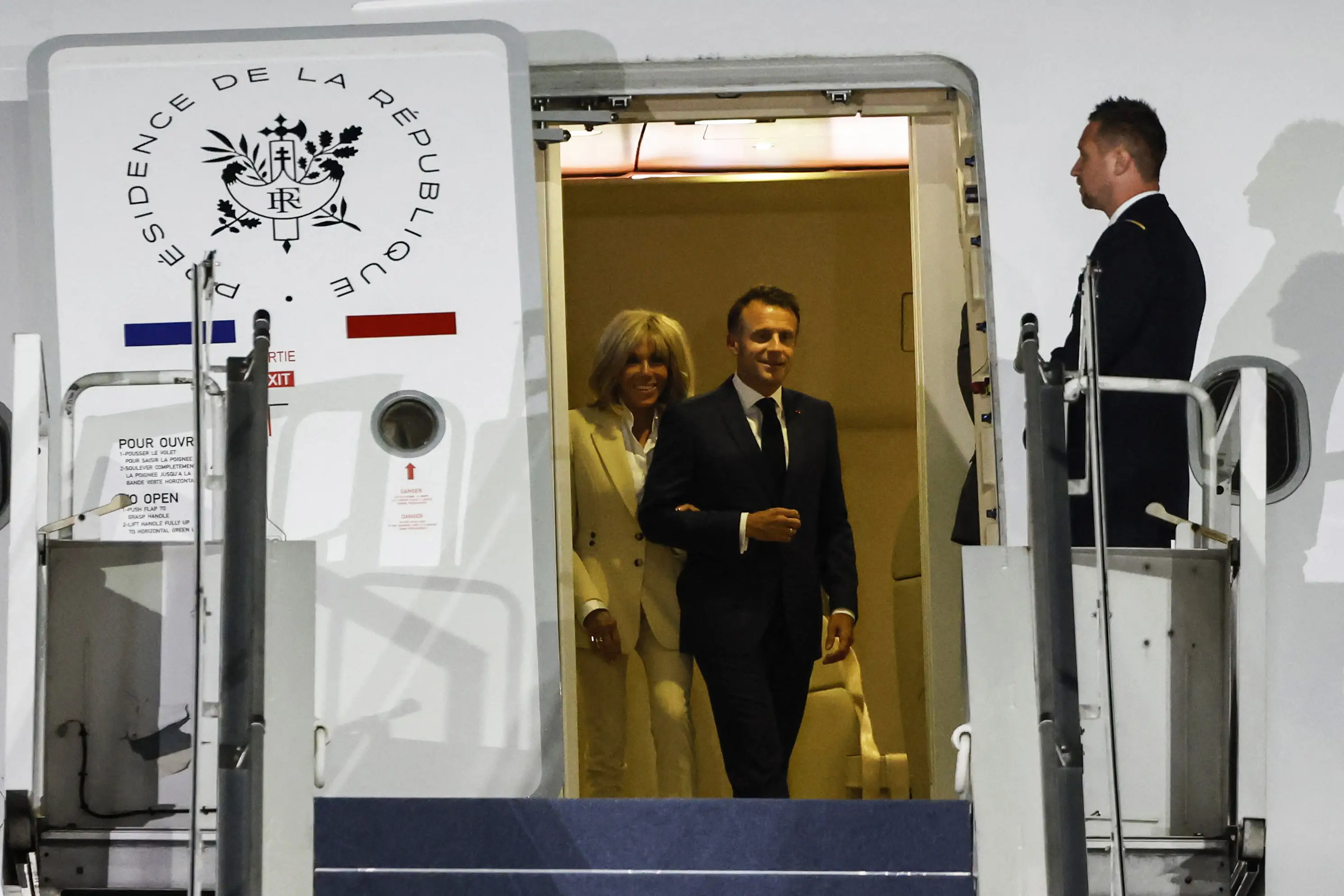 The couple put on a united front as they landed in Indonesia (LUDOVIC MARIN/AFP via Getty Images)