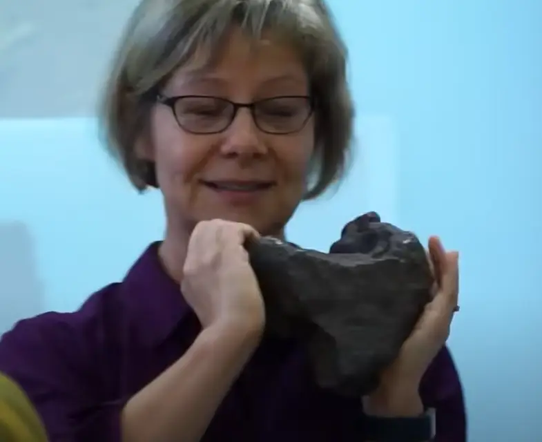 Researcher Monaliza Sirbescu with the rock (Central Michigan University)
