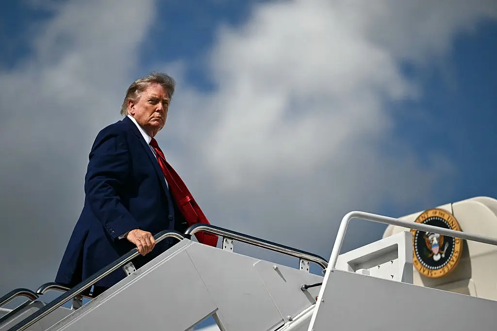 Mr Trump pictured boarding Air Force One (Kent NISHIMURA / AFP via Getty Images)