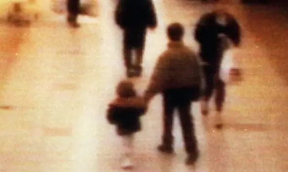 James Bulger being led away in the New Strand shopping centre (Malcolm Croft/PA)