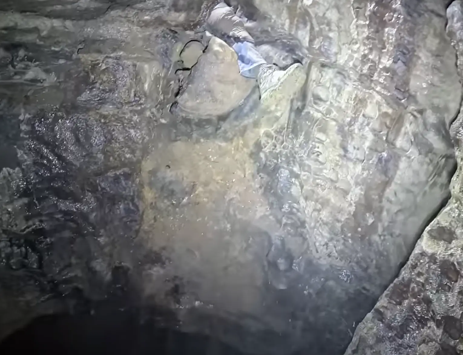 He left his leg out so his friend could climb up it and not fall down the chasm. (YouTube/ActionAdventureTwins)