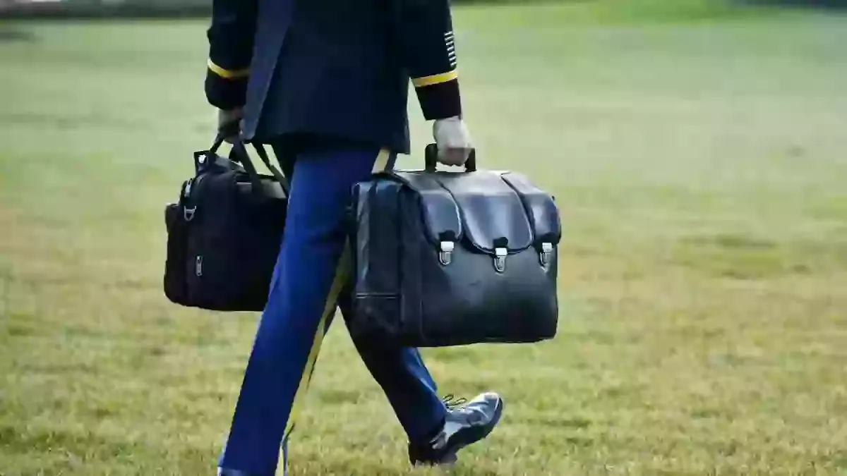 The biscuit is currently carried around in a briefcase, but it was suggested that someone carry a butcher's knife instead (BRYAN DOZIER/Middle East Images/AFP via Getty Images)