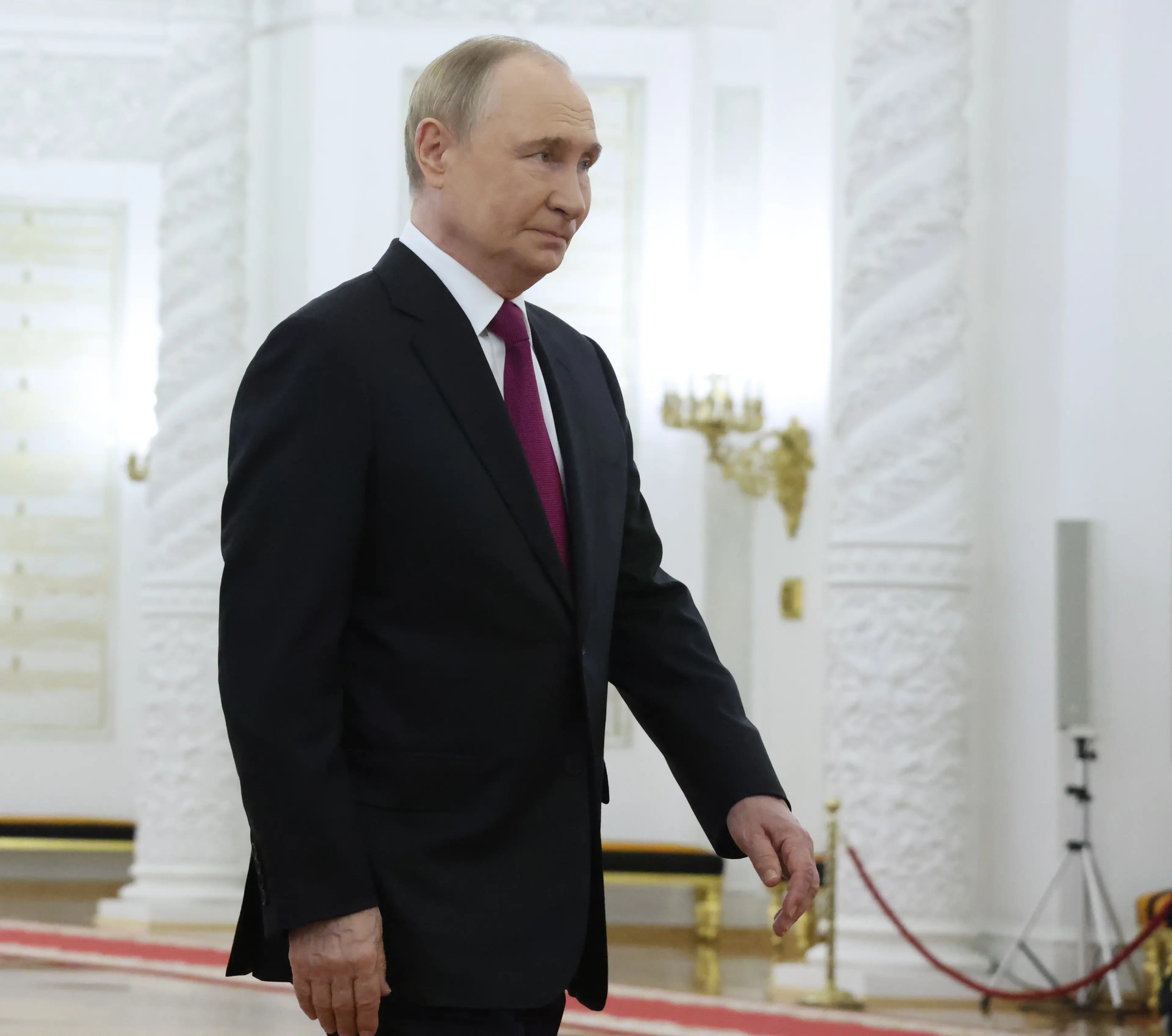 Putin's deliberate posture is designed to keep his weapon close and maintain readiness (Getty/Contributor)