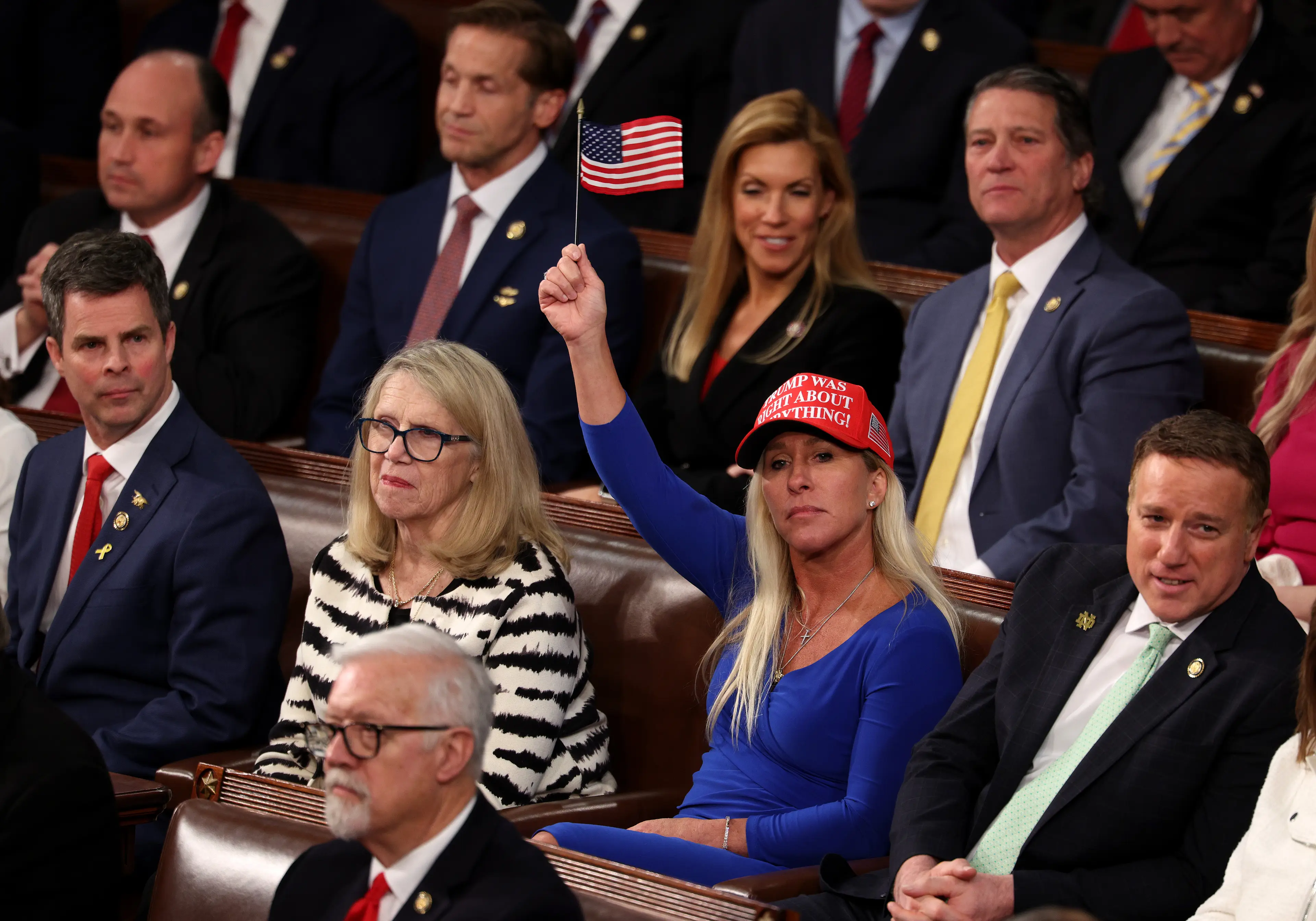 Marjorie Taylor Greene (the one wearing a hat and waving a flag) used to be a big figure for MAGA, but she's since fallen out with Donald Trump over the Epstein files (Kayla Bartkowski/Getty Images)