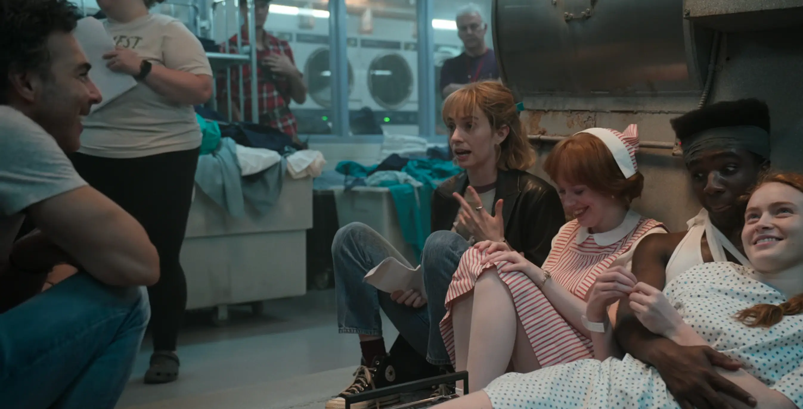 Maya Hawke is shown reminding Levy that Lucas does not yet know about Vickie and Robin in this scene (Netflix)