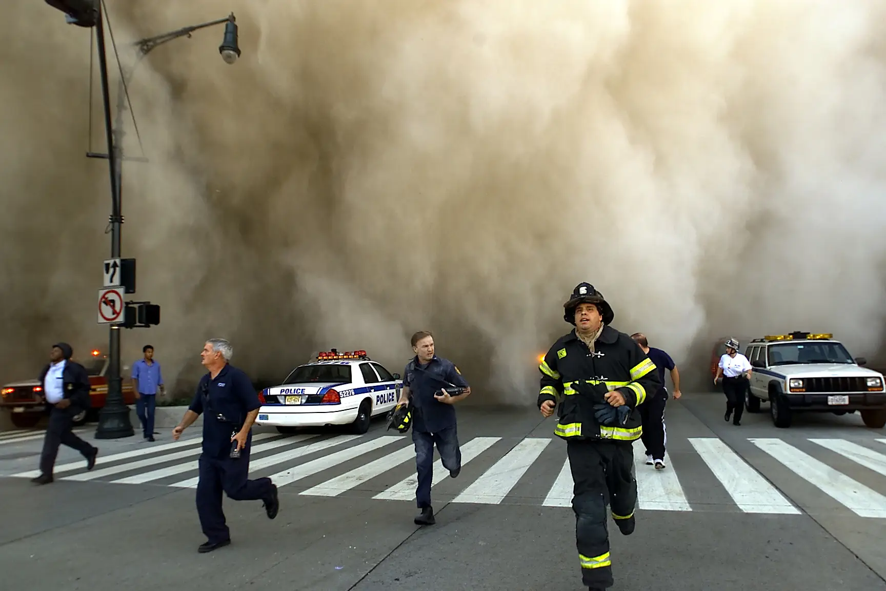 A huge dust cloud seen engulfing the street as the first tower collapsed in September 2001 (Jose Jimenez/Primera Hora/Getty Images)