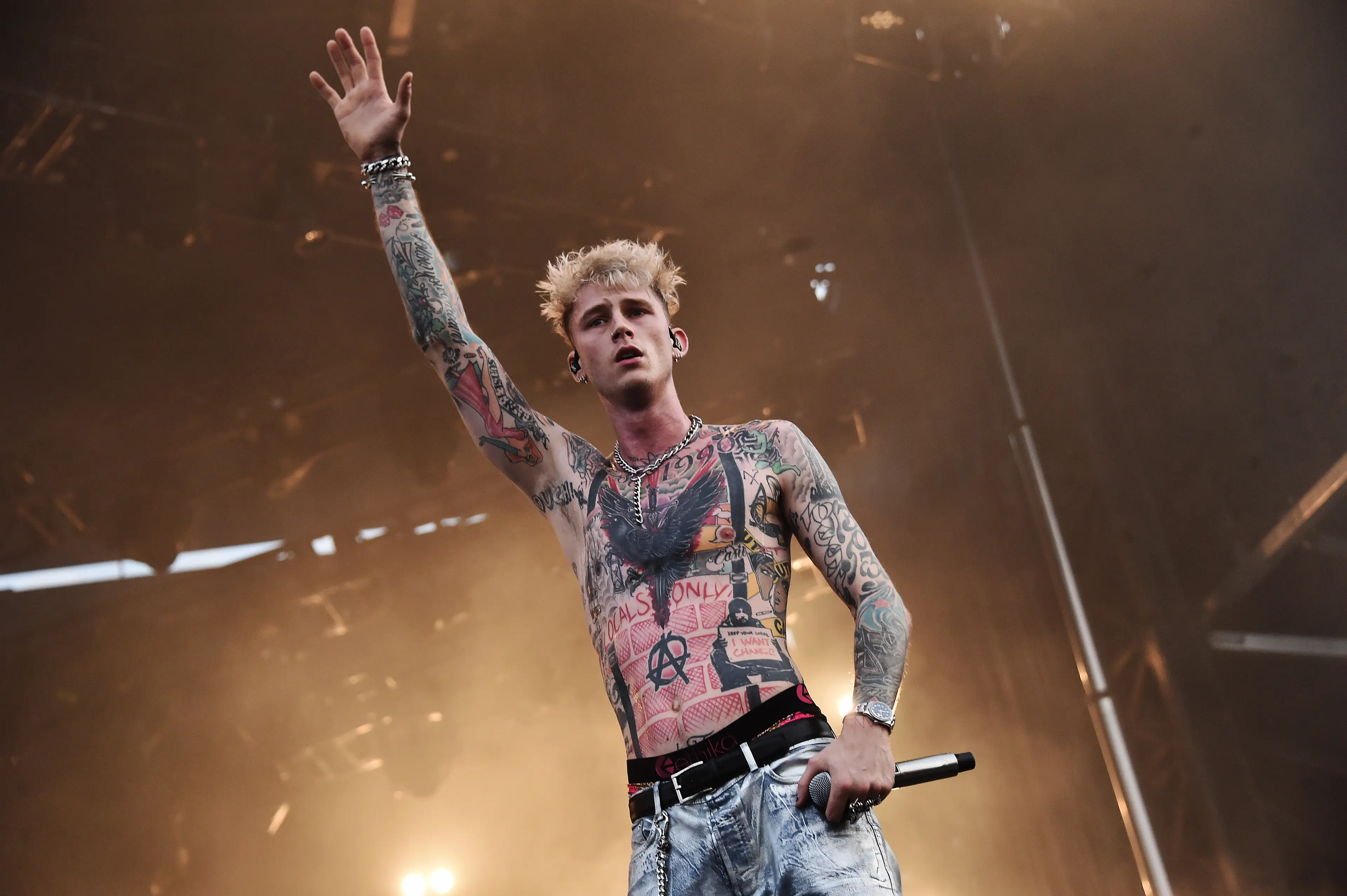 MGK, pictured in 2019, was covered in a variety of tatts (Steven Ferdman/Getty Images)