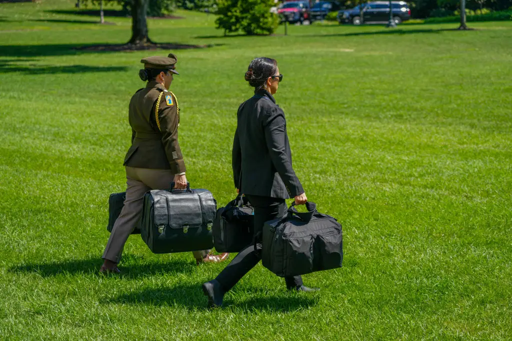 A military aide carries the 'nuclear football', which contains launch codes for nuclear weapons (Andrew Leyden / NurPhoto via Getty Images)