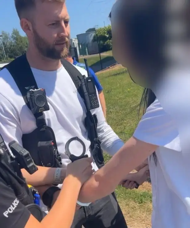 The officers were videoed handcuffing the girl.