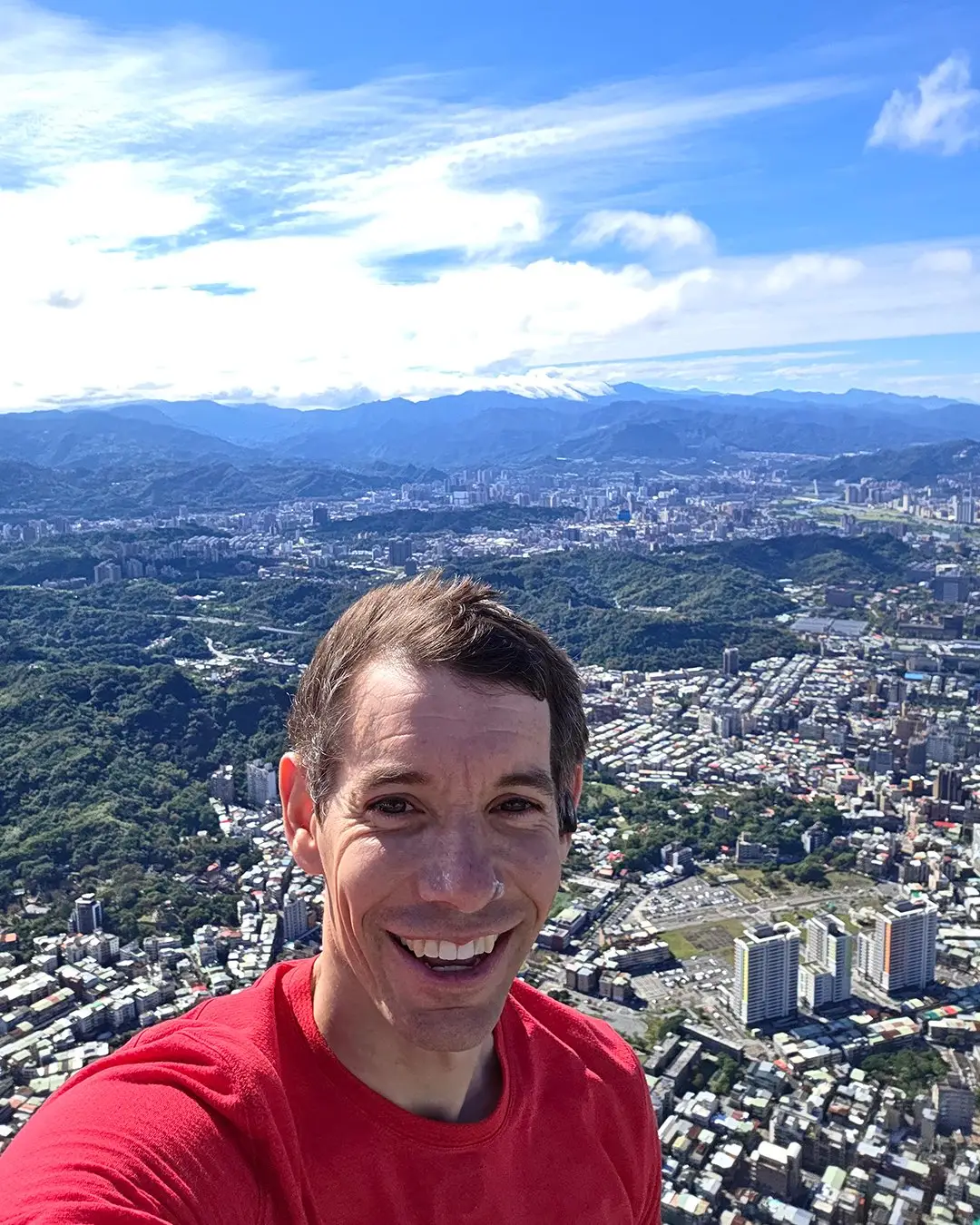 Alex Honnold takes selfie on top of the Taipei 101 skyscraper. Image credit: Netflix