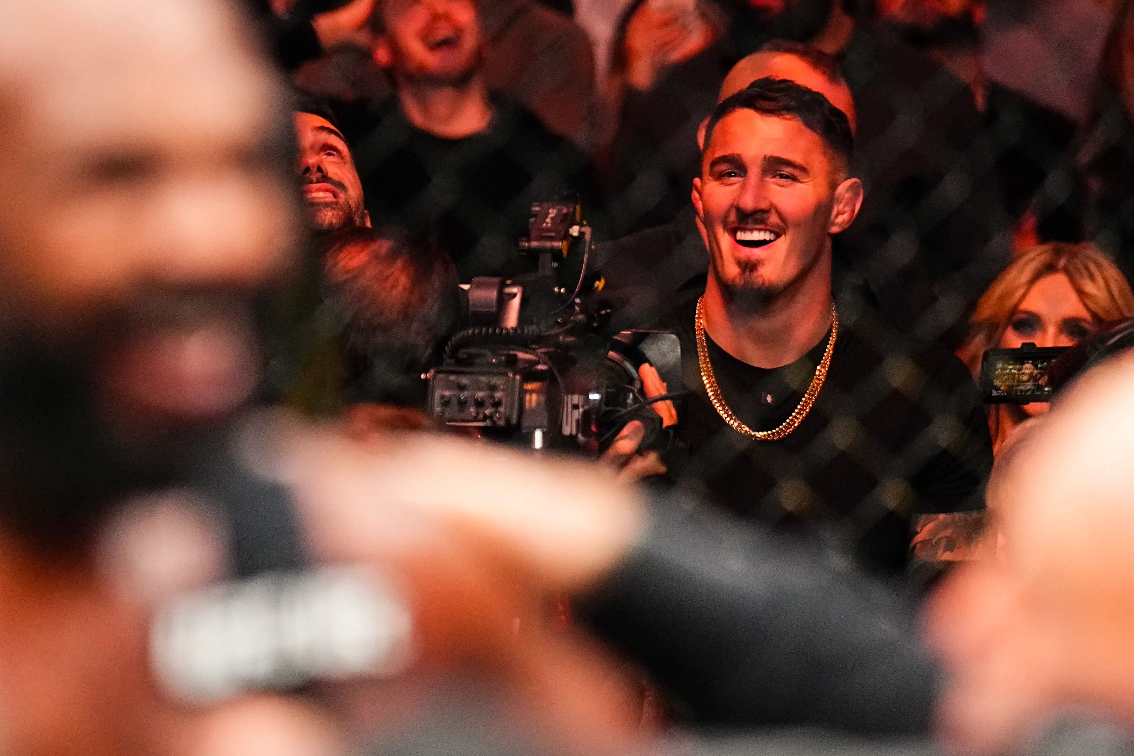 Tom Aspinall looks on as Jon Jones speak after his victory over Stipe Miocic. Image: Getty 