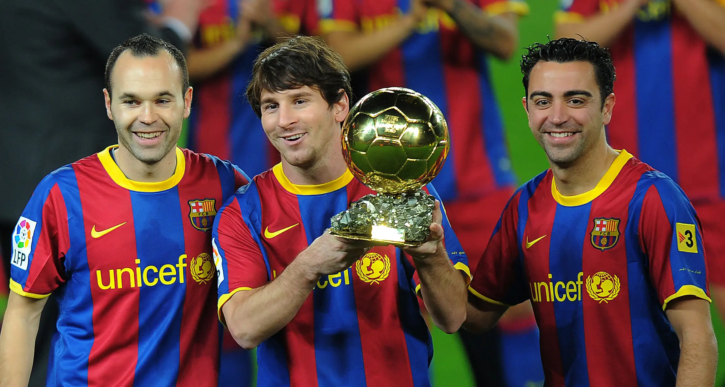 Lionel Messi pictured with the Ballon d'Or award, flanked by Andres Iniesta and Xavi. Image: Getty 