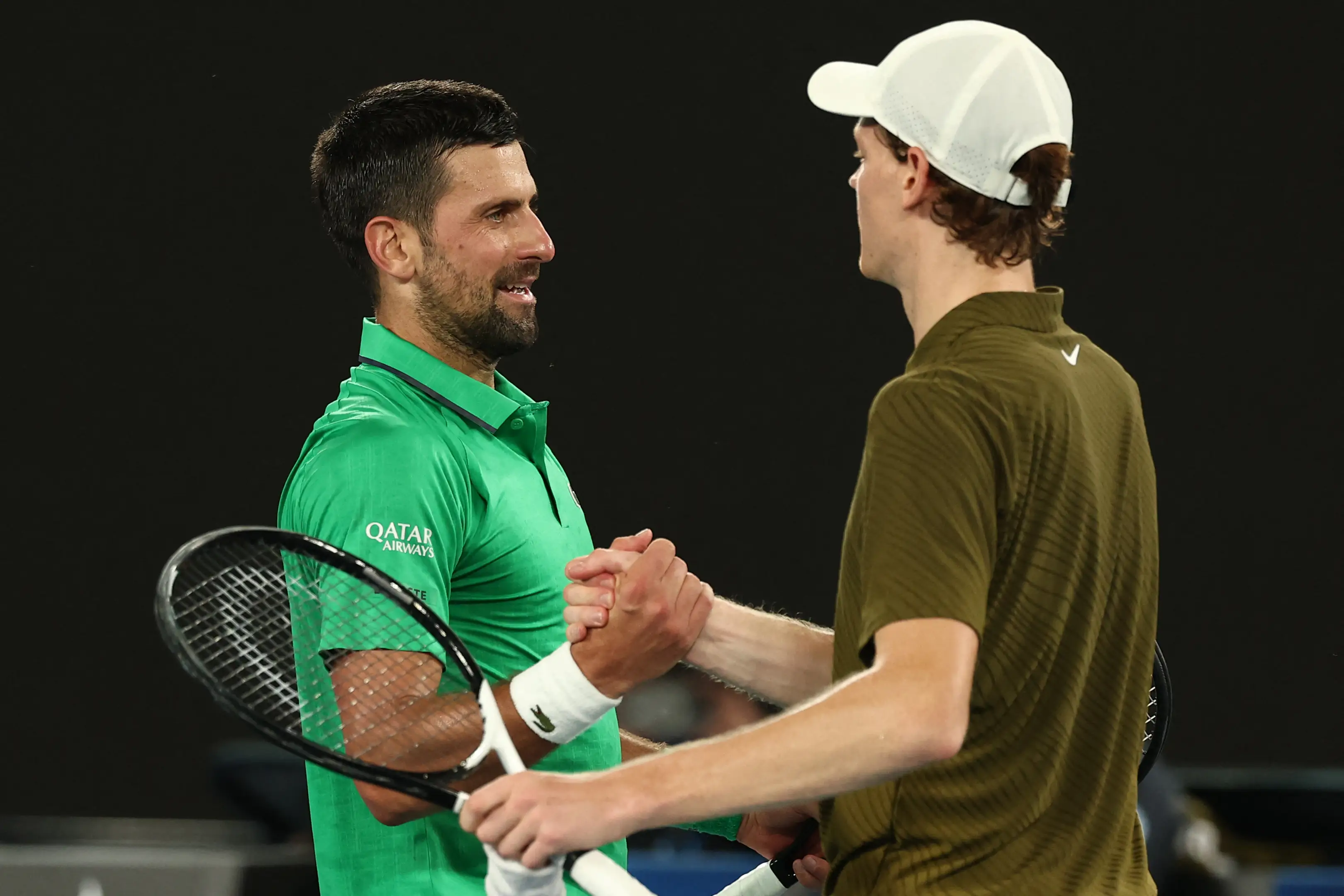 Serbia's Novak Djokovic (L) greets Italy's Jannik Sinner after winning their men's singles semi-final match on day thirteen of the Australian Open (Getty Images)