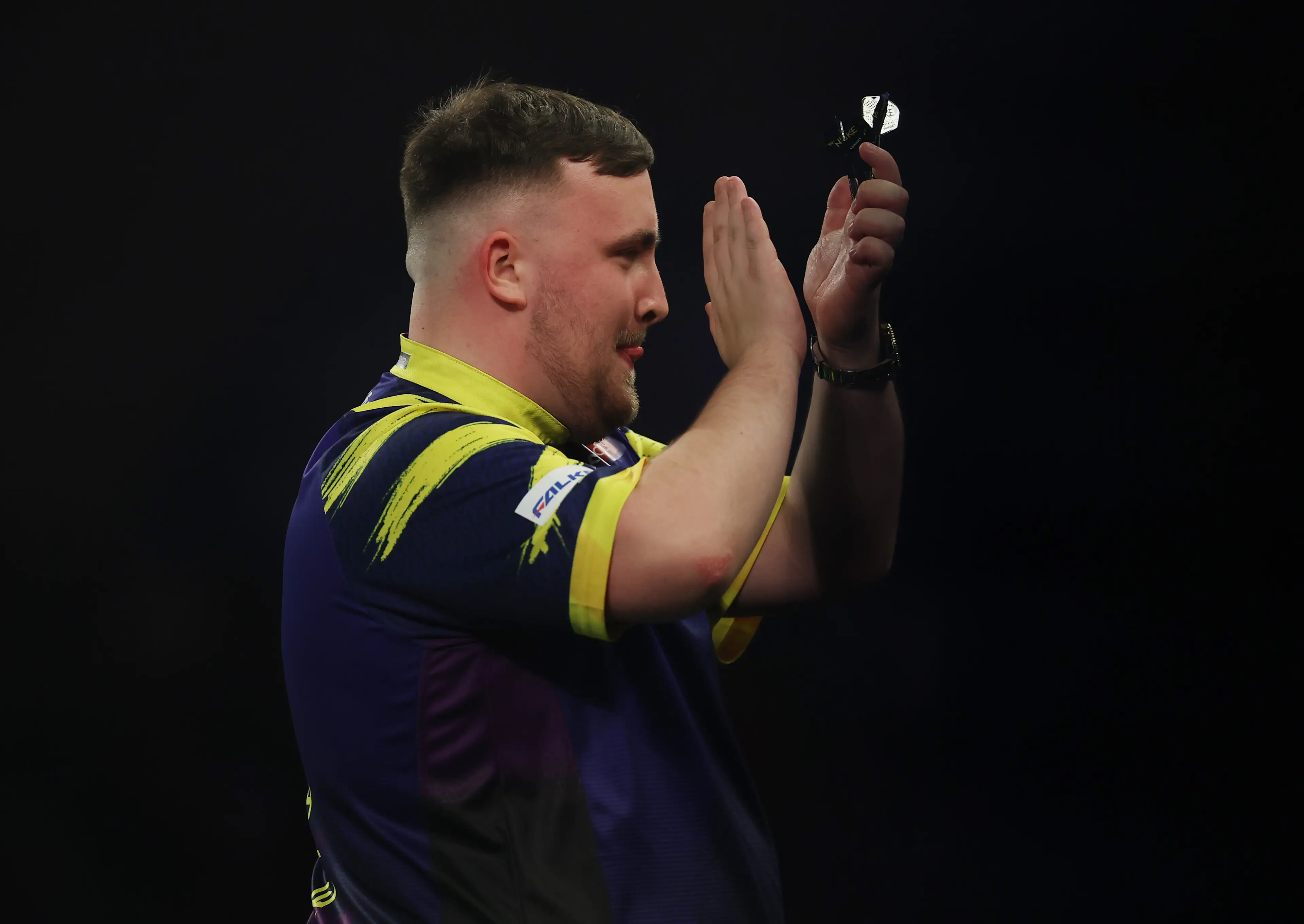 Luke Littler celebrates his victory over Ryan Searle at the World Darts Championship. Image: Getty 