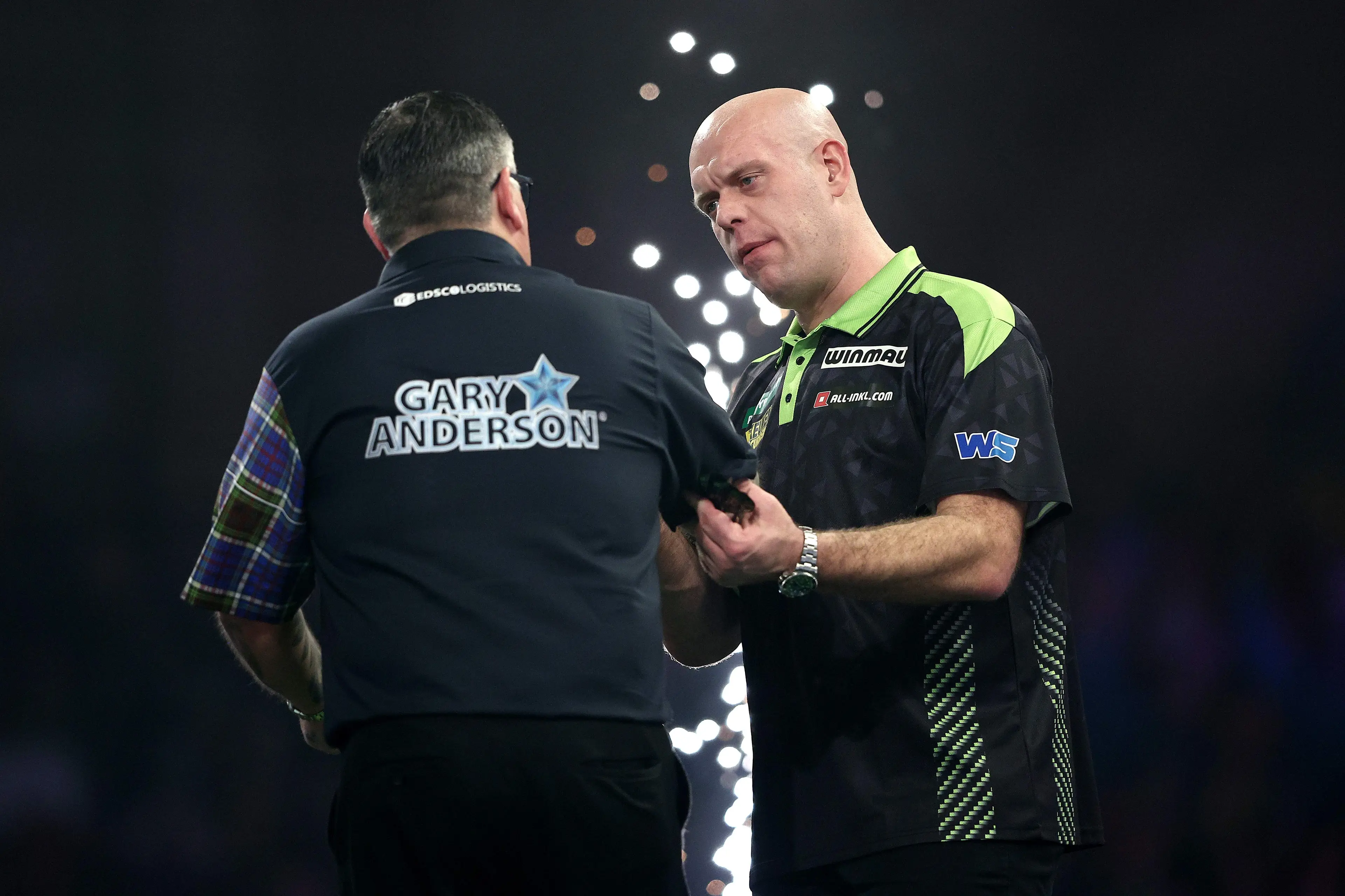 Gary Anderson and Michael van Gerwen share an embrace after their World Darts Championship clash. Image: Getty
