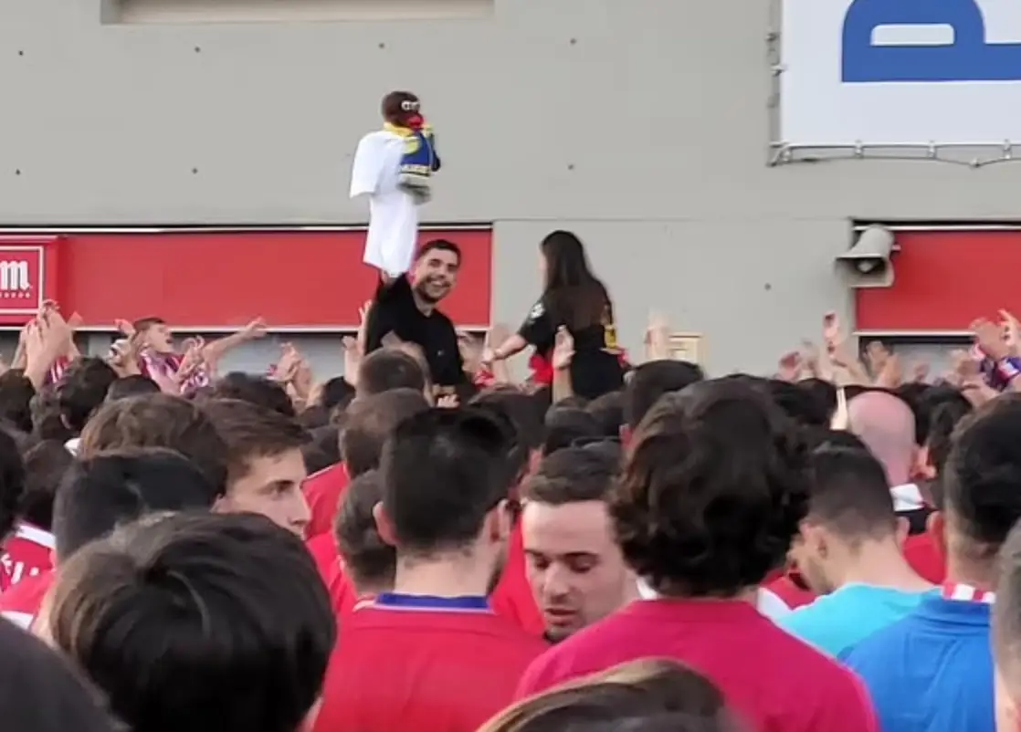 One fan was seen holding a racist doll outside the stadium (Image: Twitter)