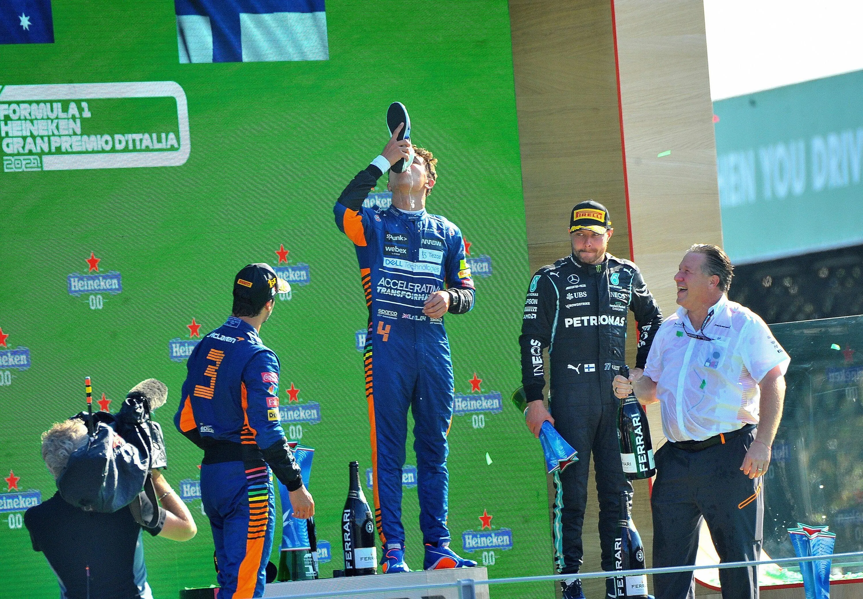 Lando 'enjoys' his first shoey, an experience he's unlikely to replicate. Image: PA Images