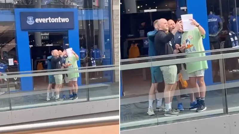 Liverpool fans sing 'You'll Never Walk Alone' outside Everton club shop using 'lyric sheet'