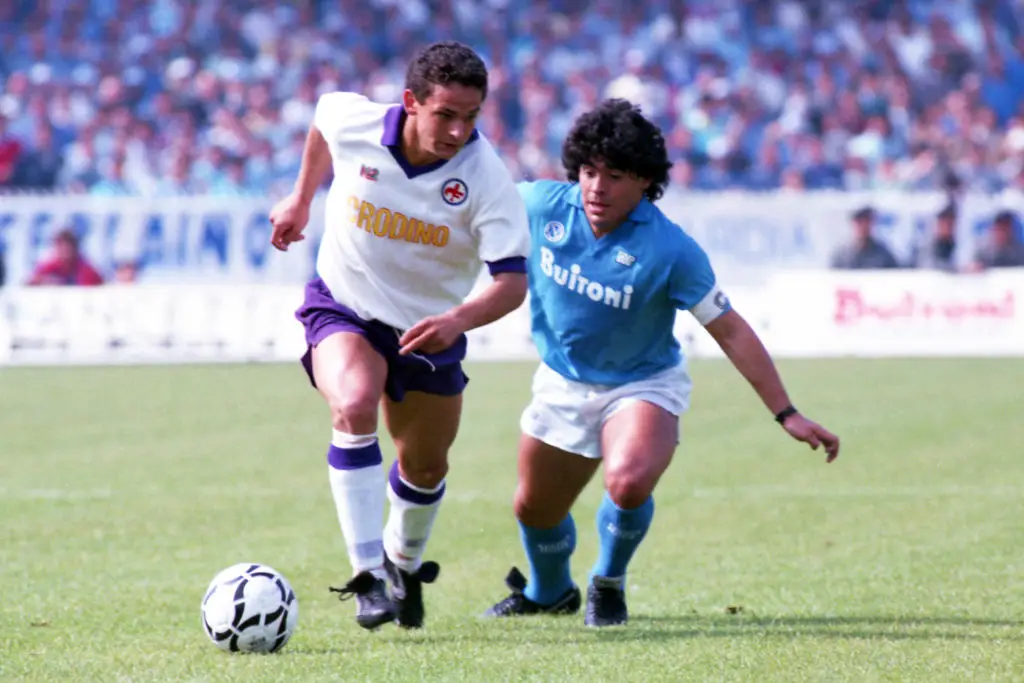 Roberto Baggio and Diego Maradona battle for the ball -