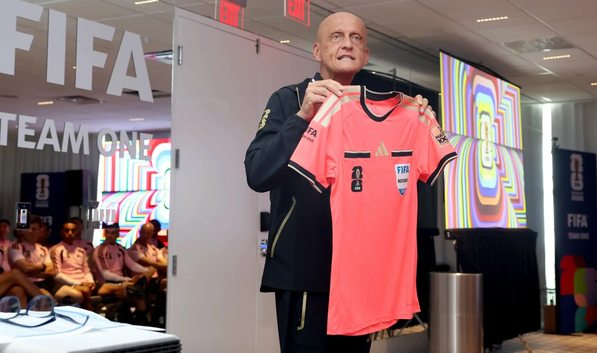 Collina holds up the shirt. Image credit: FIFA
