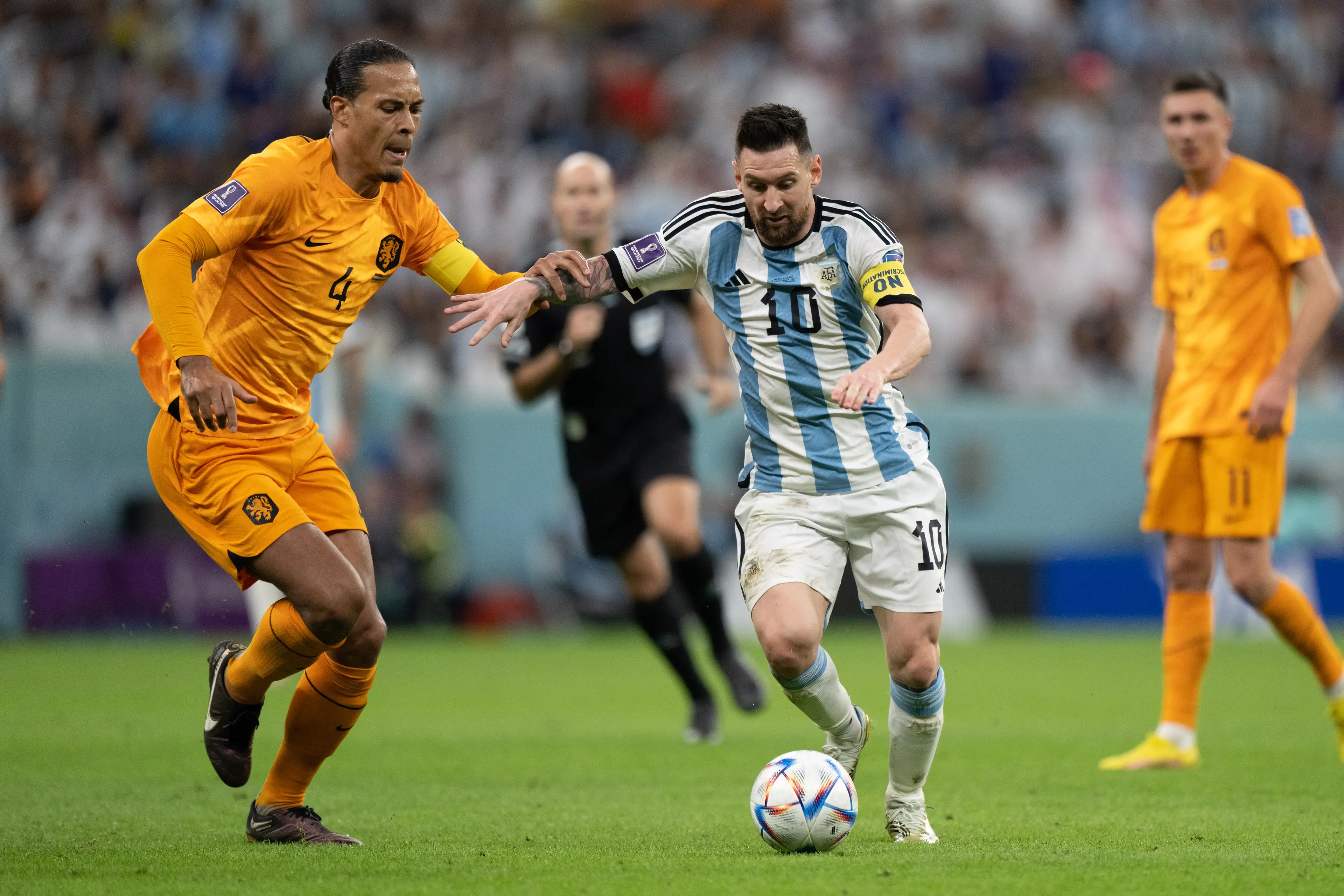Lionel Messi and Virgil van Dijk in action during the 2022 World Cup. Image: Getty 