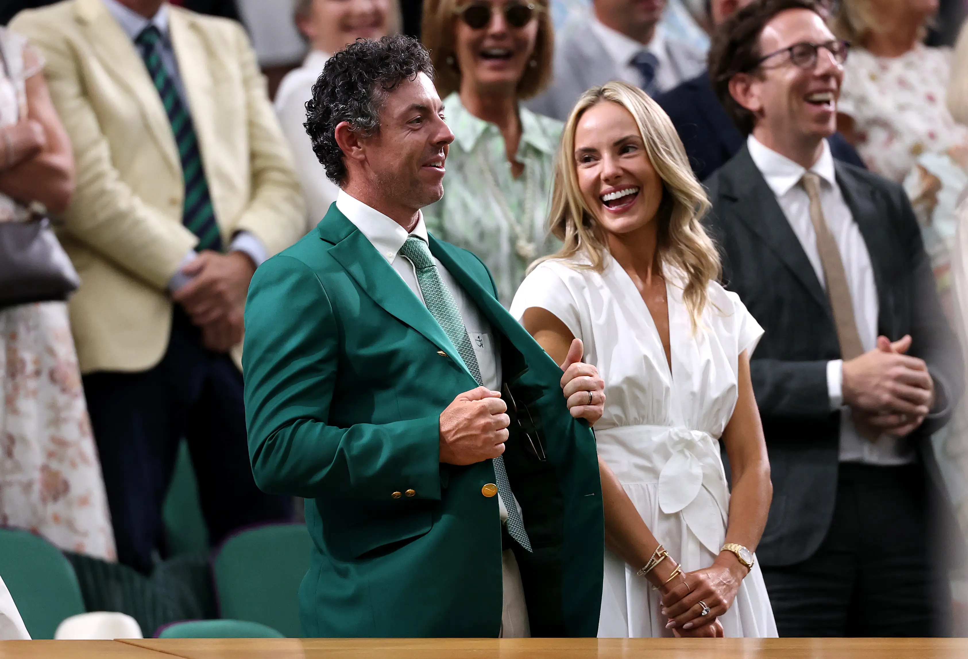 Golfer Rory McIlroy is seen in the Royal Box with partner Erica Stoll as Novak Djokovic of Serbia speaks to him during a post-victory speech (Getty Images)