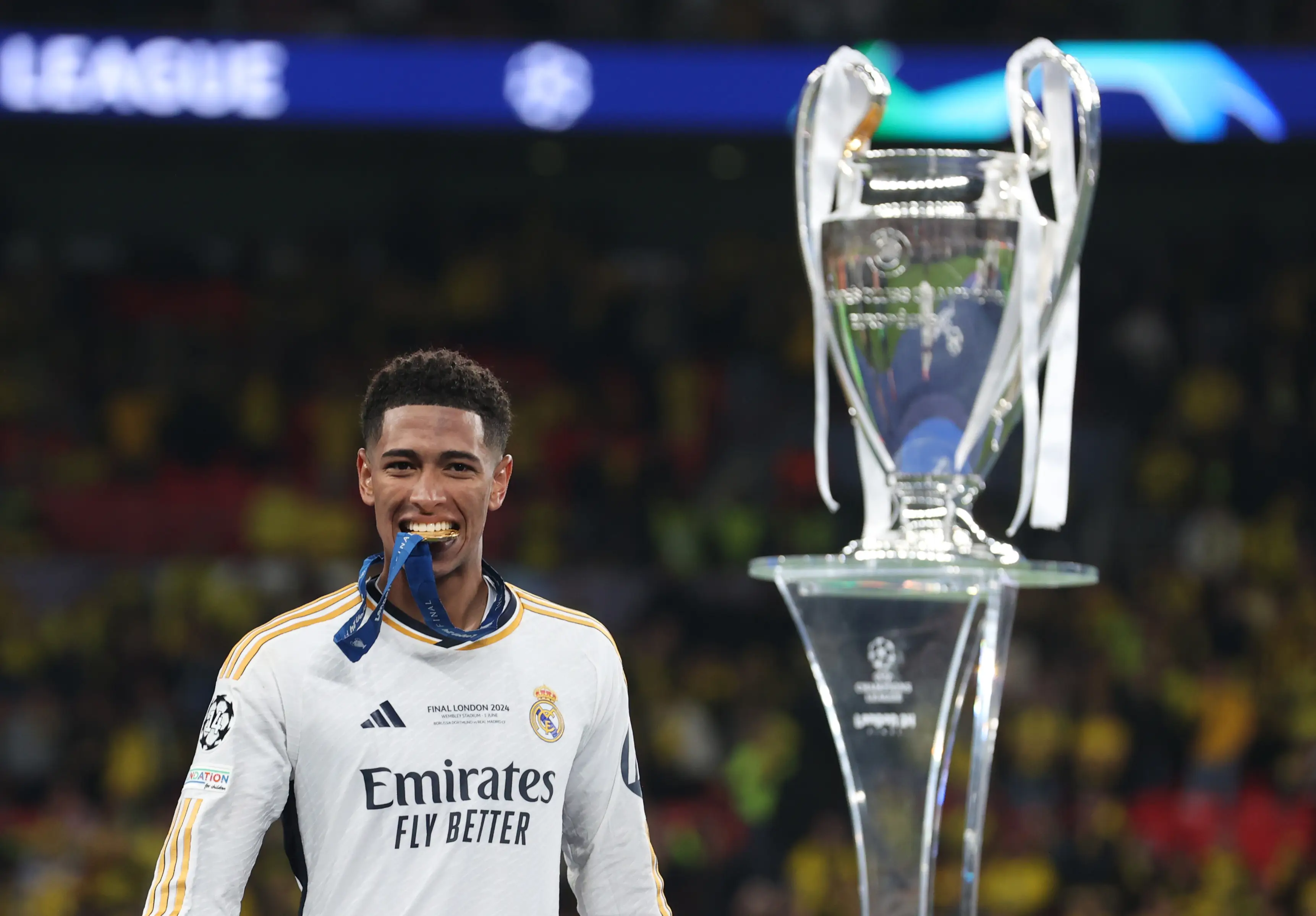 Jude Bellingham bites into his medal after winning the Champions League with Real Madrid. Image: Getty 