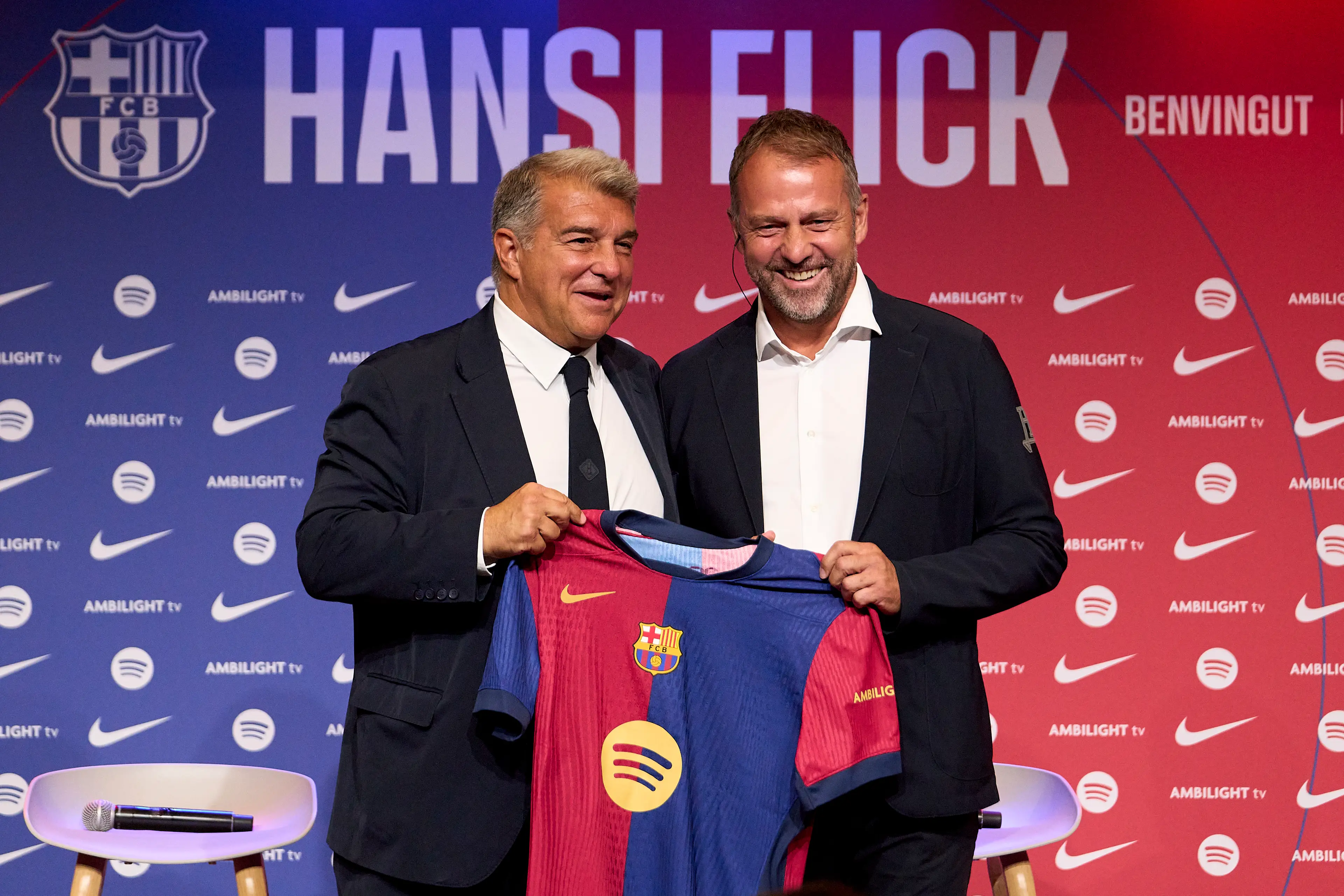 Current Barcelona boss Hansi Flick holding the club's famous red and white shirt. (Image: Getty)