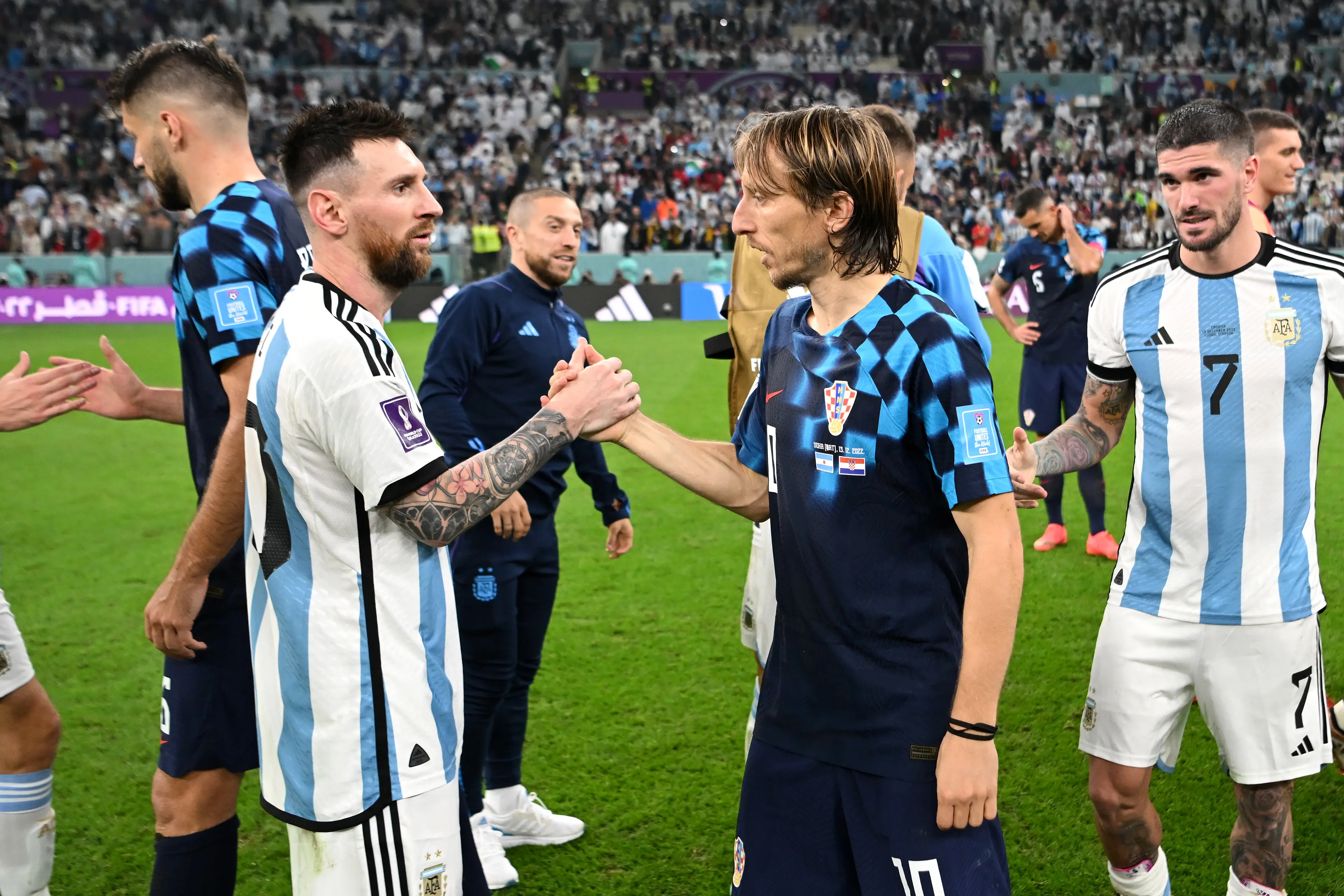 Lionel Messi and Luka Modric share a warm embrace following their World Cup clash. Image: Getty