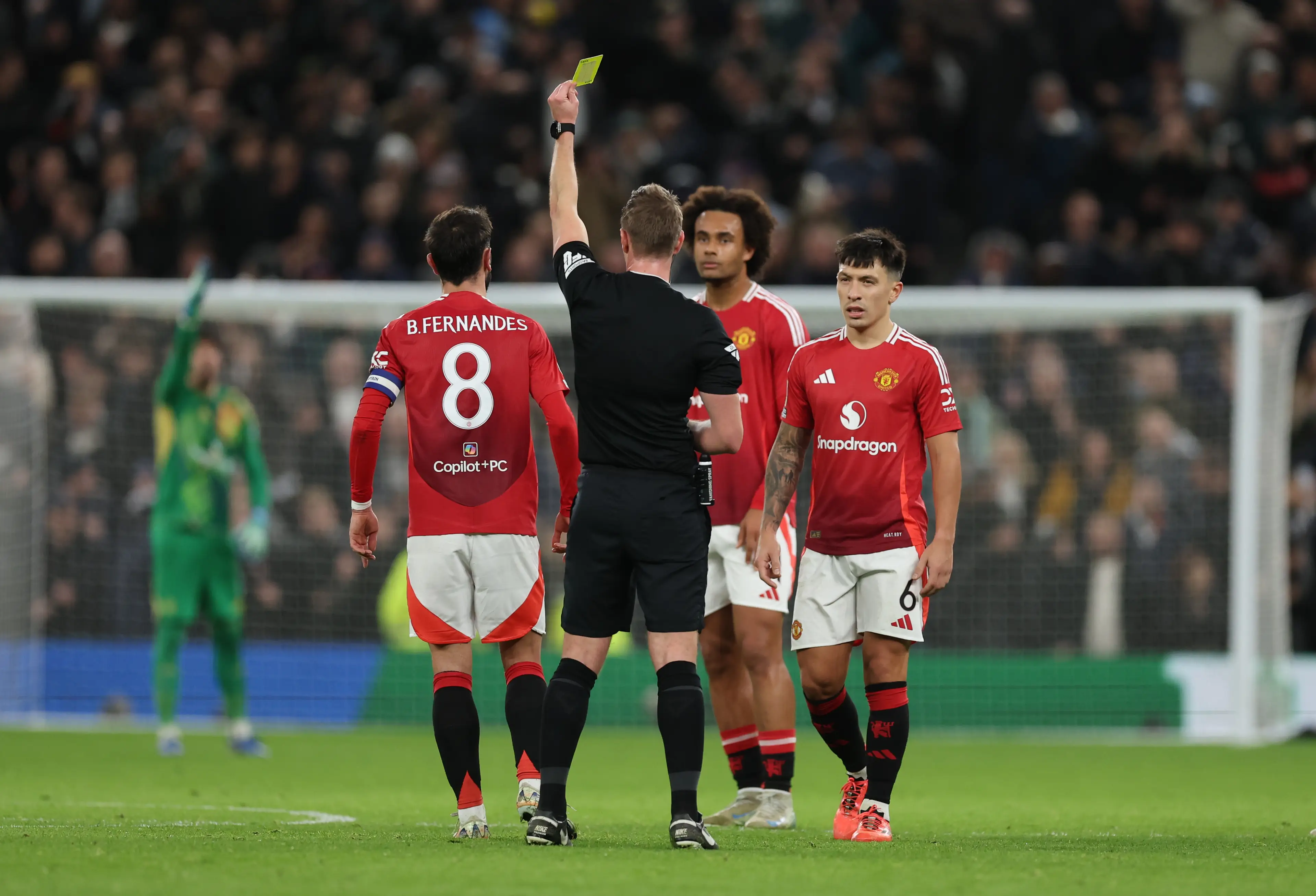 Bruno Fernandes is yellow carded by referee John Brooks for his complaints. Image: Getty