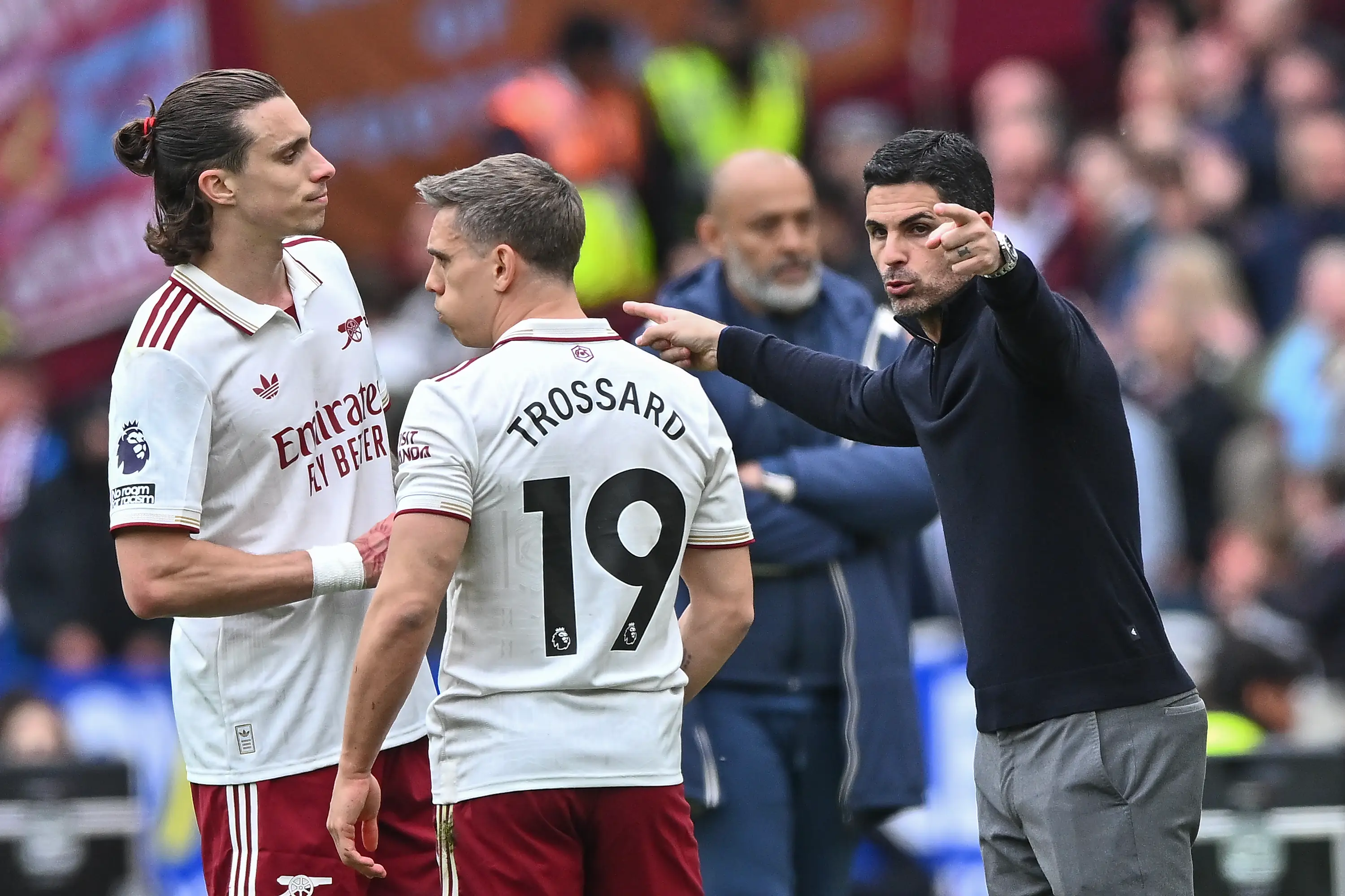 Mikel Arteta manager of Arsenal speaks with Riccardo Calafiori of Arsenal and Leandro Trossard of Arsenal during the Premier League match between West Ham United and Arsenal (Getty Images)