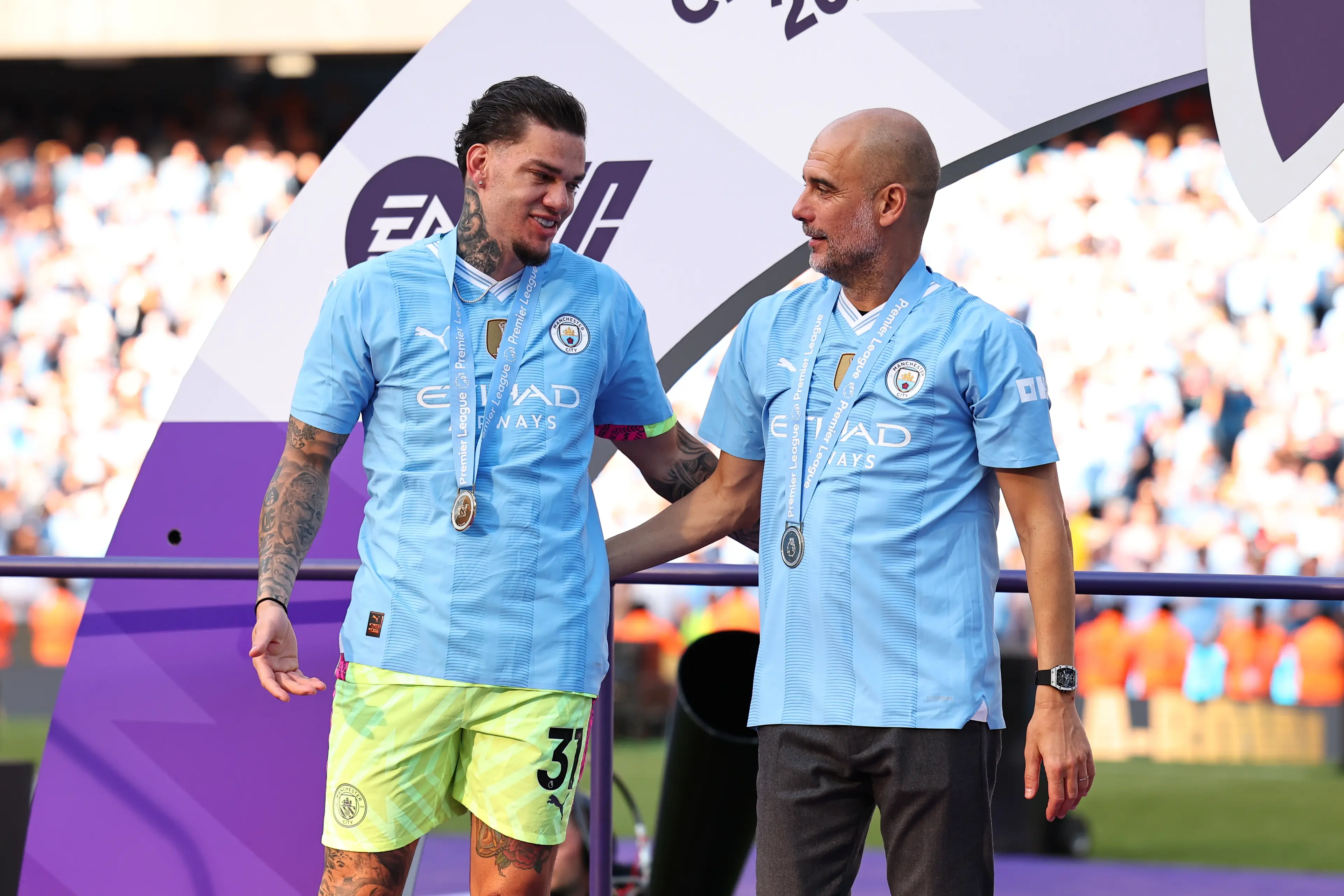 Manchester City's Ederson and Pep Guardiola. (
