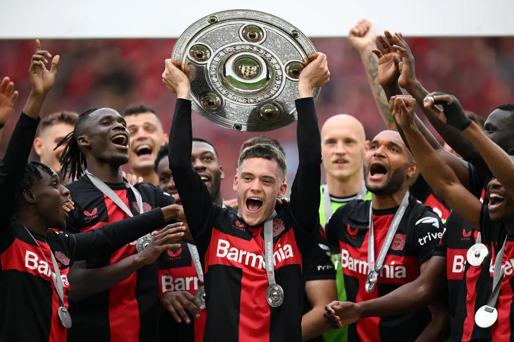 Bayer Leverkusen star Florian Wirtz (centre) lifts the Bundesliga trophy (