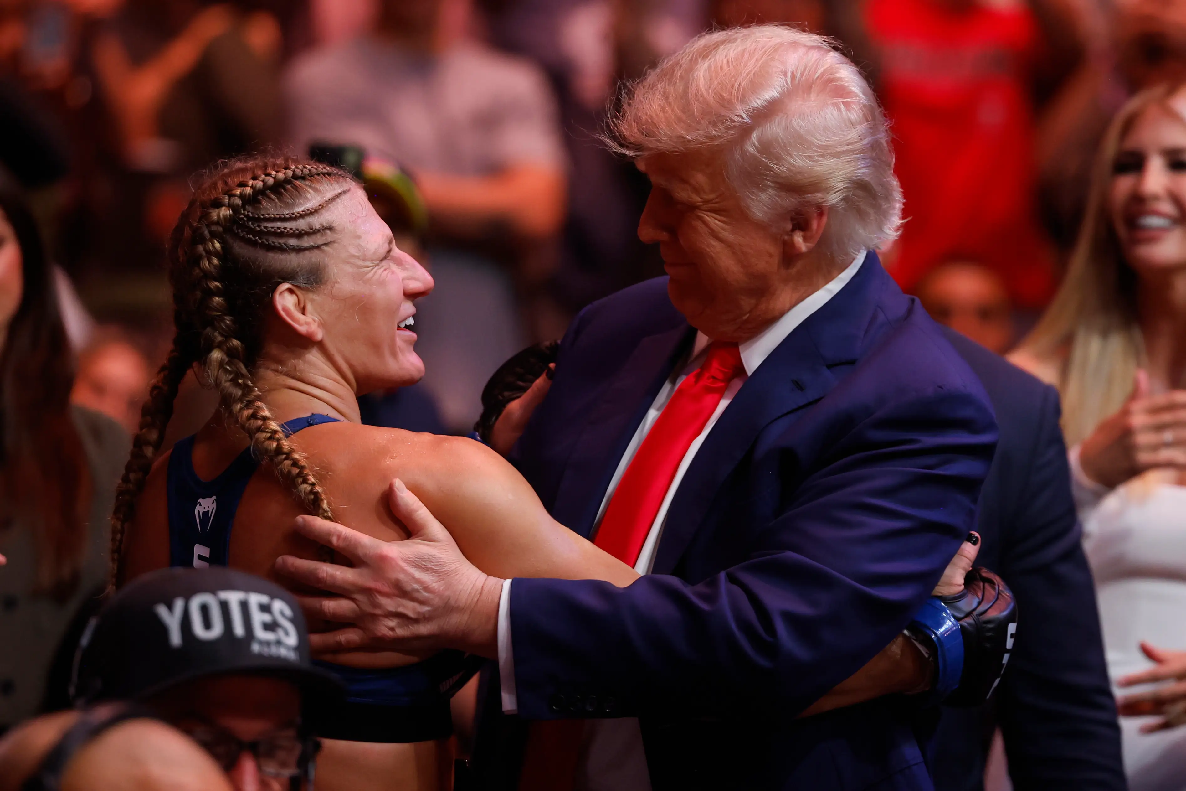 Kayla Harrison celebrates with Donald Trump after winning the UFC women's bantamweight title. Image: Getty 