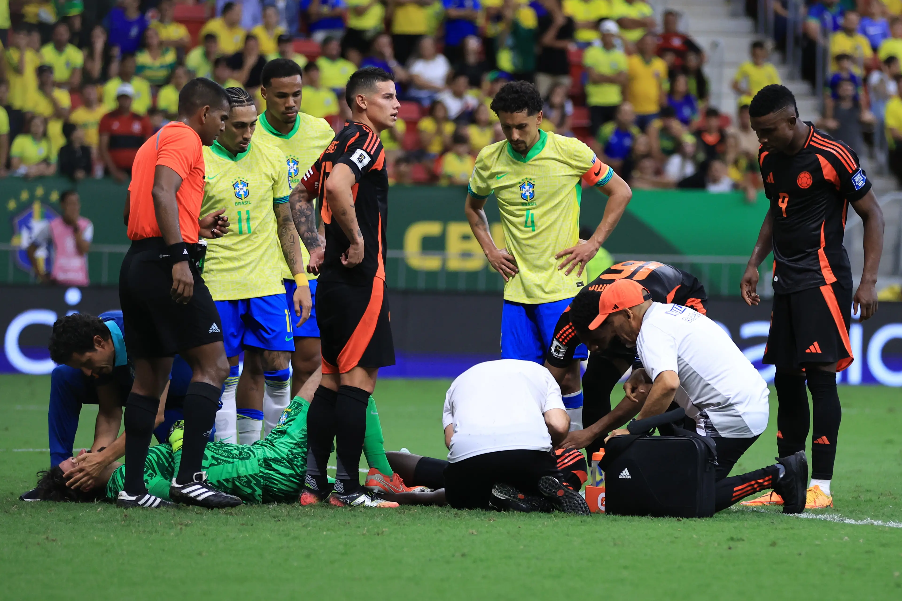 Alisson receives treatment after colliding with Davison Sanchez. Image: Getty 