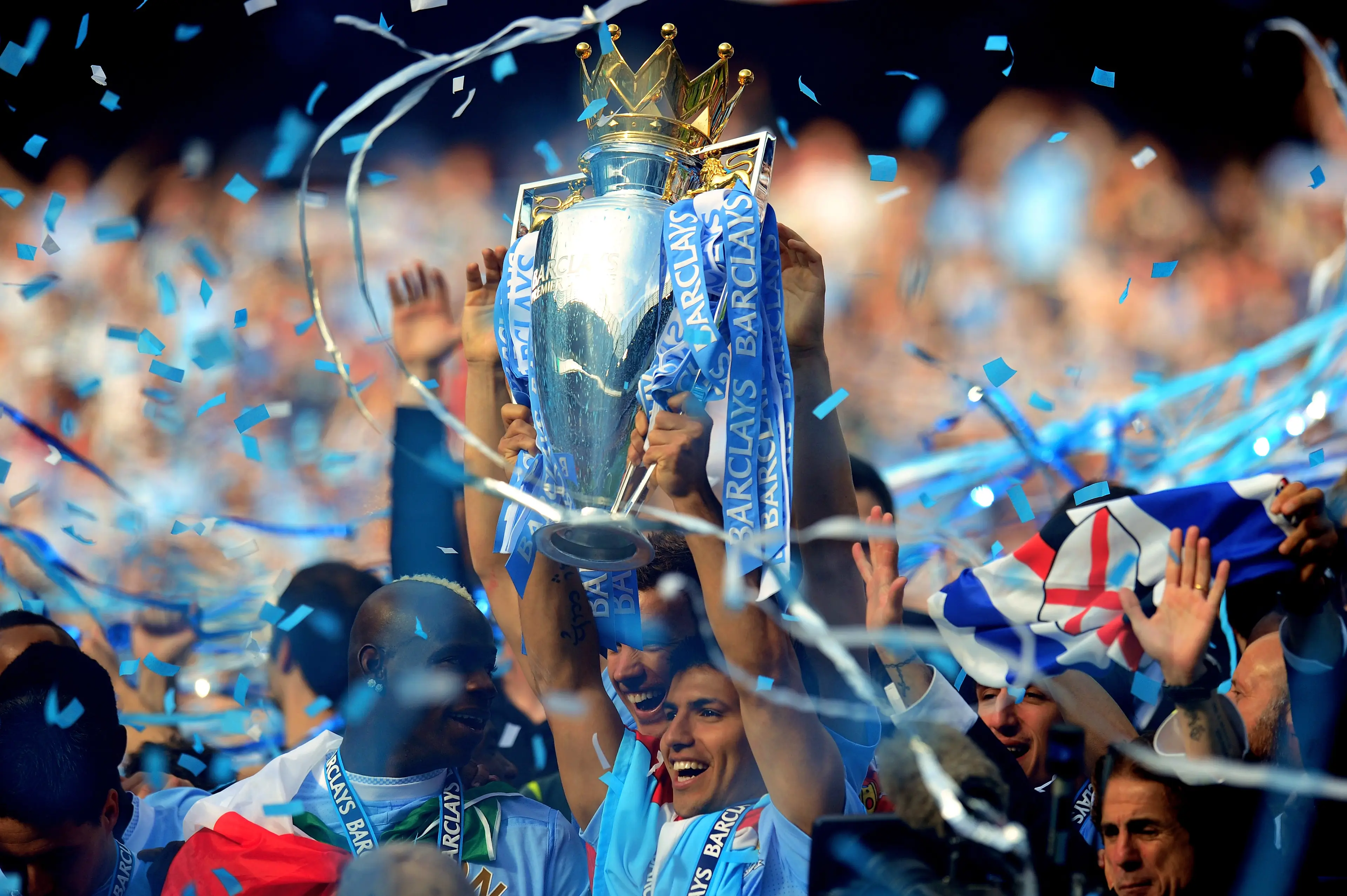 Aguero lifts the Premier League title, shortly after scoring the winner against QPR. Image credit: Getty