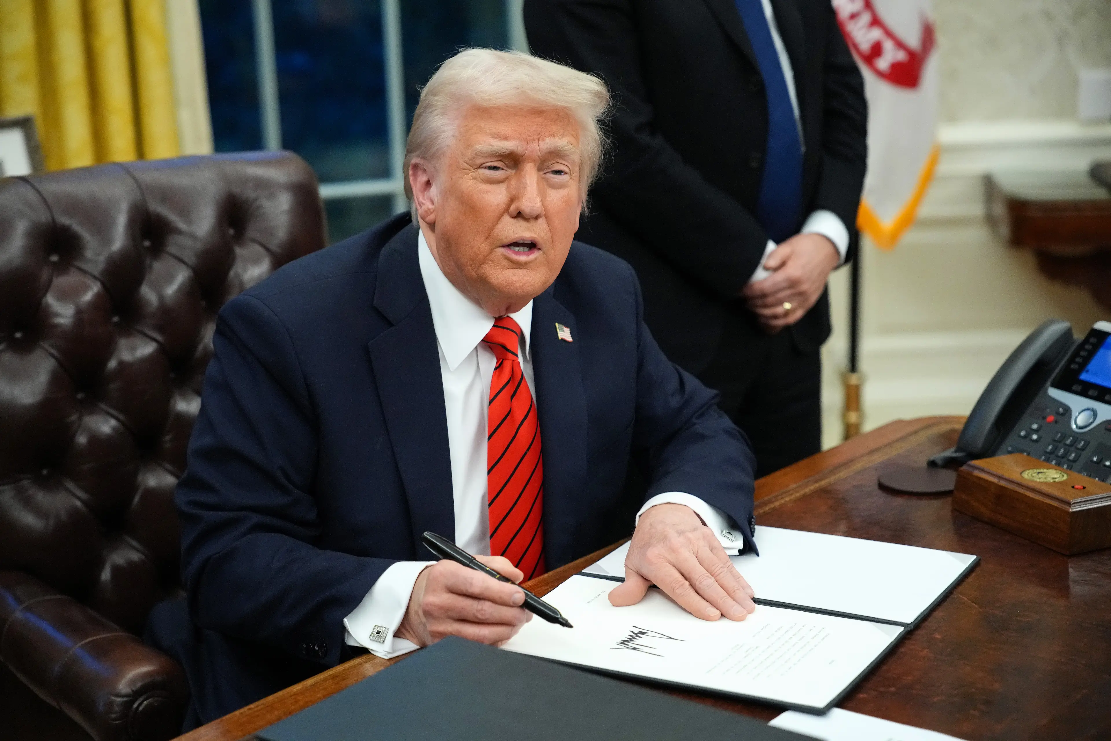 Trump signs a series of executive orders in the Oval Office at the White House on February 10, 2025. Image credit: Getty