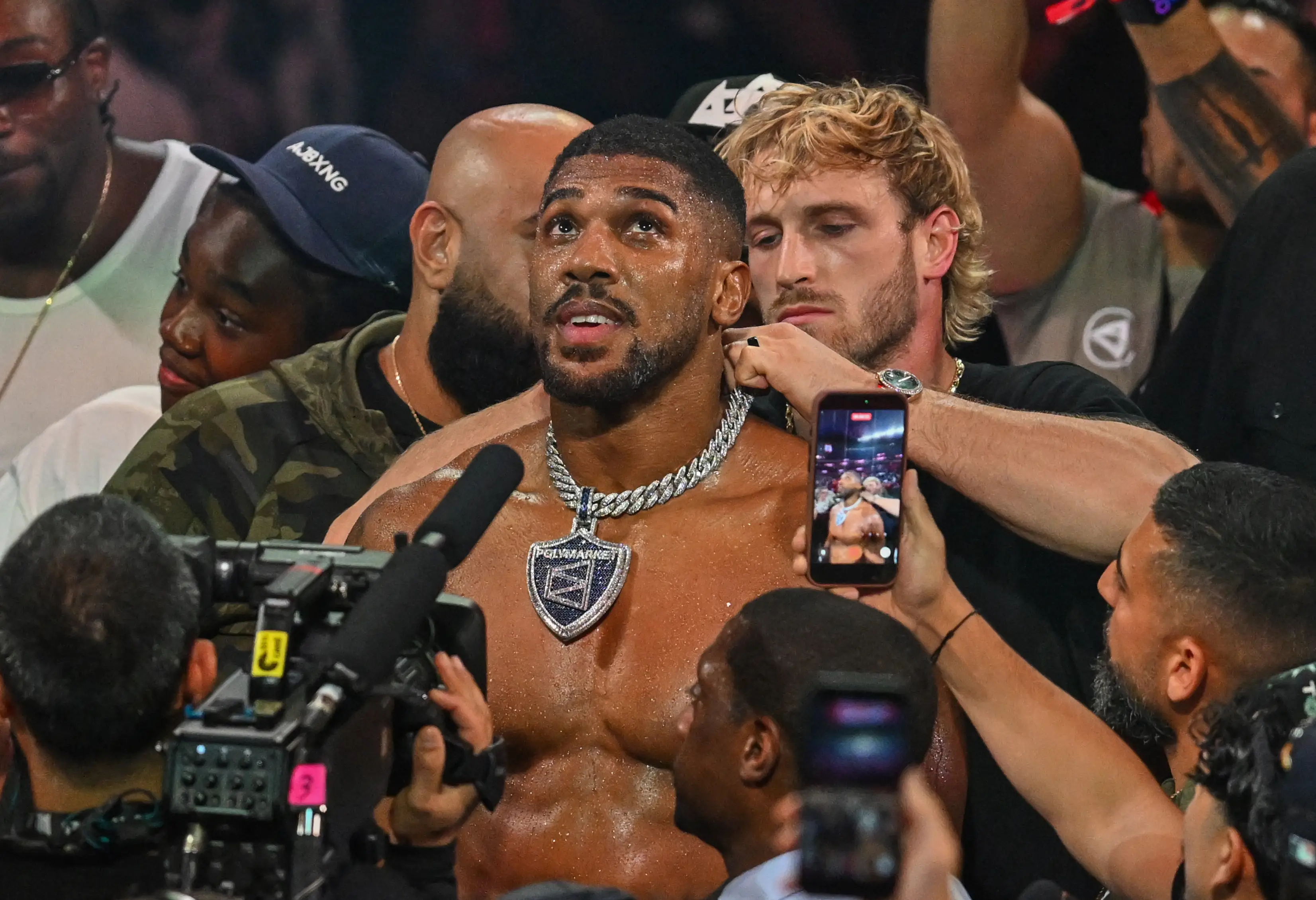 Logan Paul tried to snatch Anthony Joshua's chain after his victory over Jake Paul. Image: Getty 