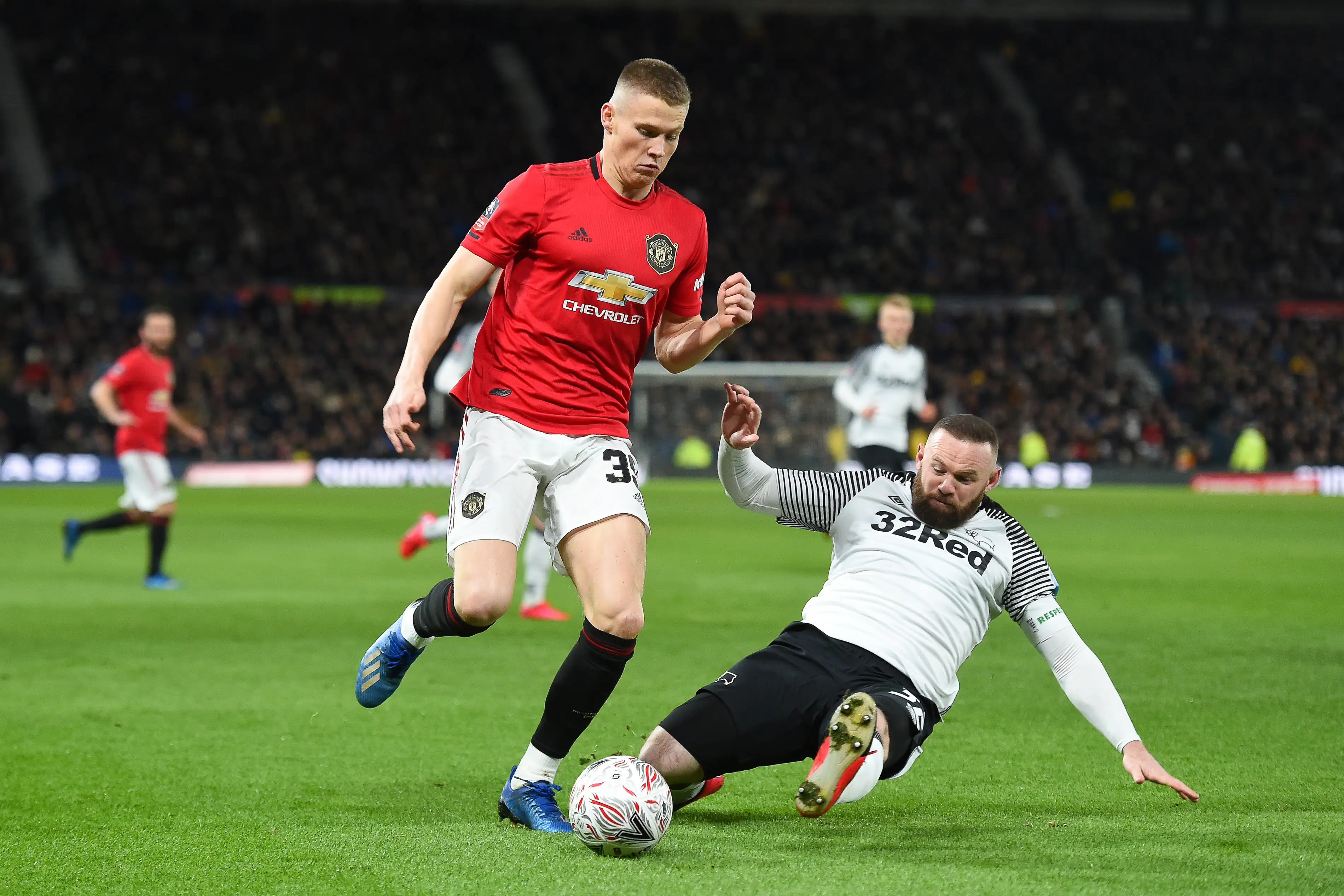 Scott McTominay and Wayne Rooney playing against each other during a fixture between Derby County and Manchester United. Image: Getty