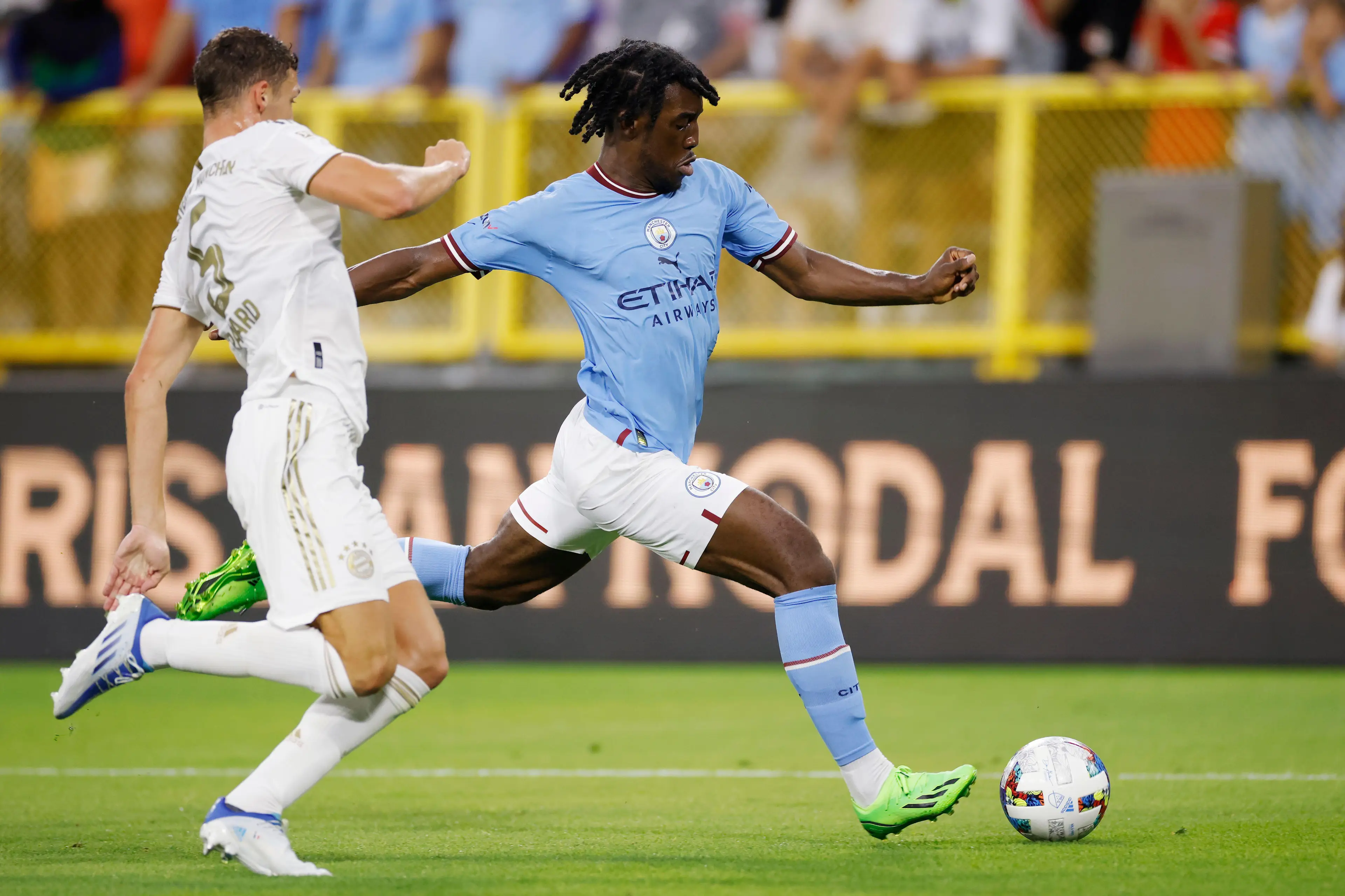Manchester City defender Josh Wilson-Esbrand (97) attempts a shot while defended by Bayern Munich defender Benjamin Pavard.