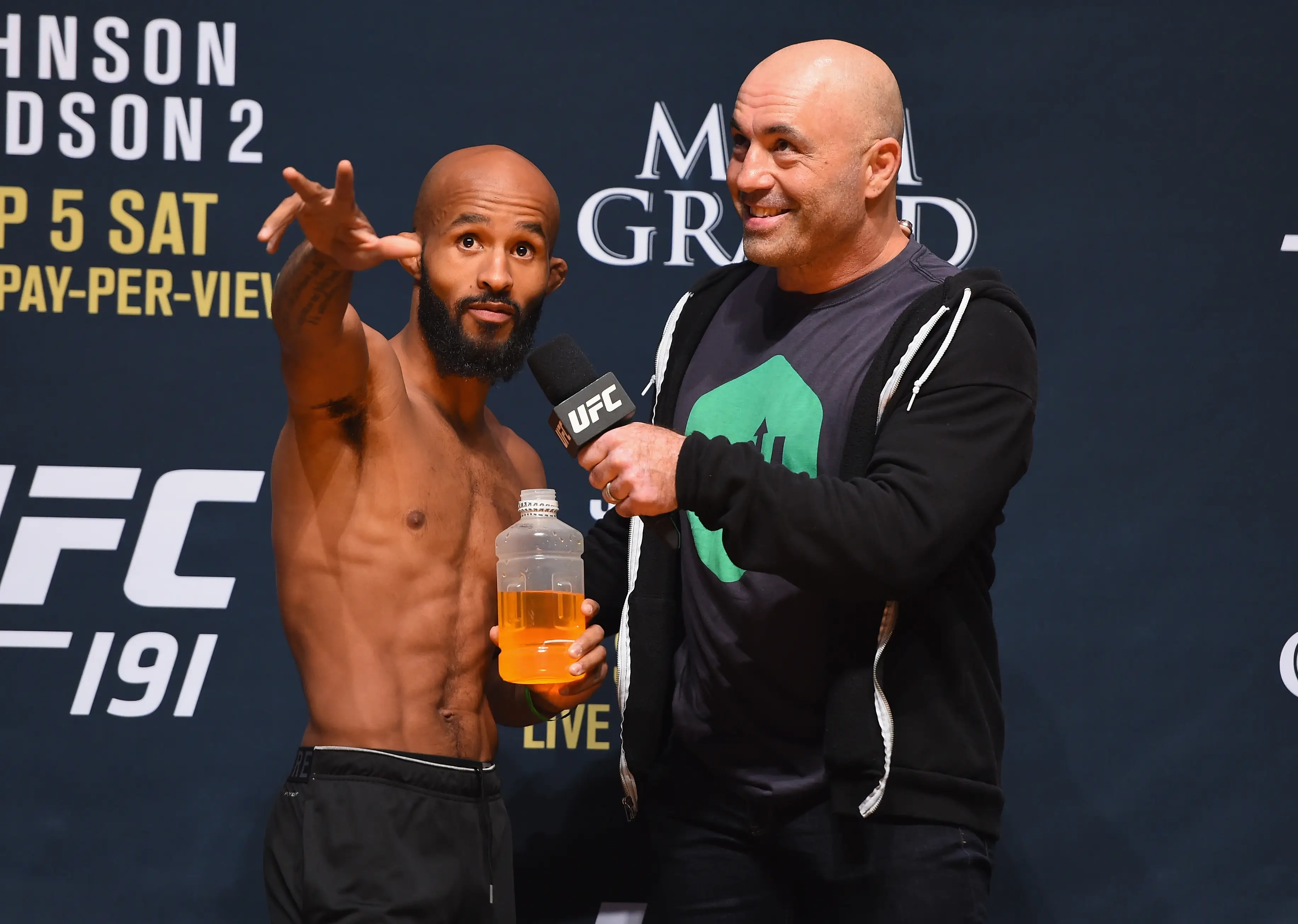 Joe Rogan with Demetrious Johnson ahead of a UFC bout. Image: Getty