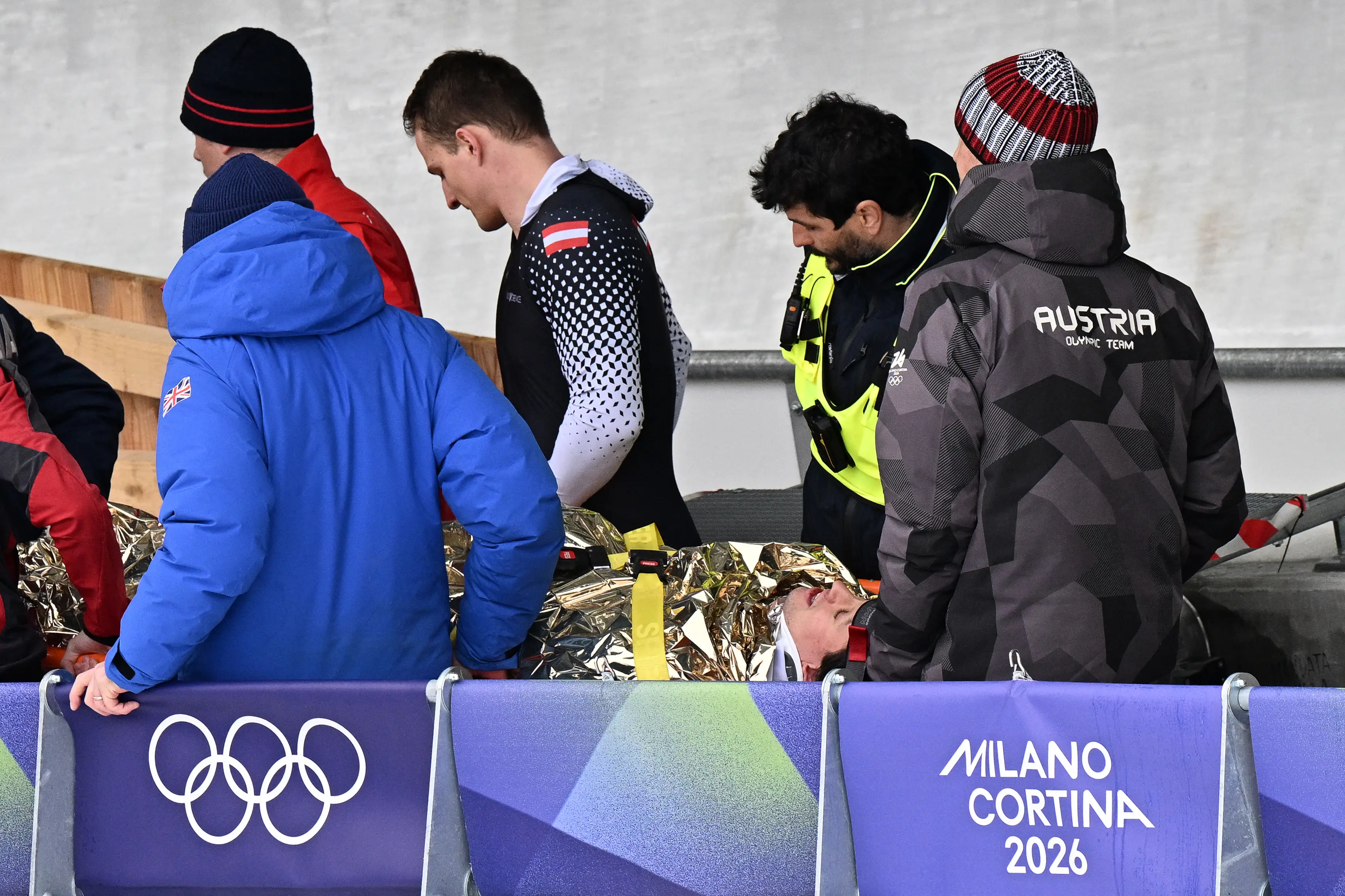Austria's Jakob Mandlbauer is brought off on a stretcher after a crash in the bobsleigh men's 4-man heat 2 at Cortina Sliding Centre. Image credit: Getty