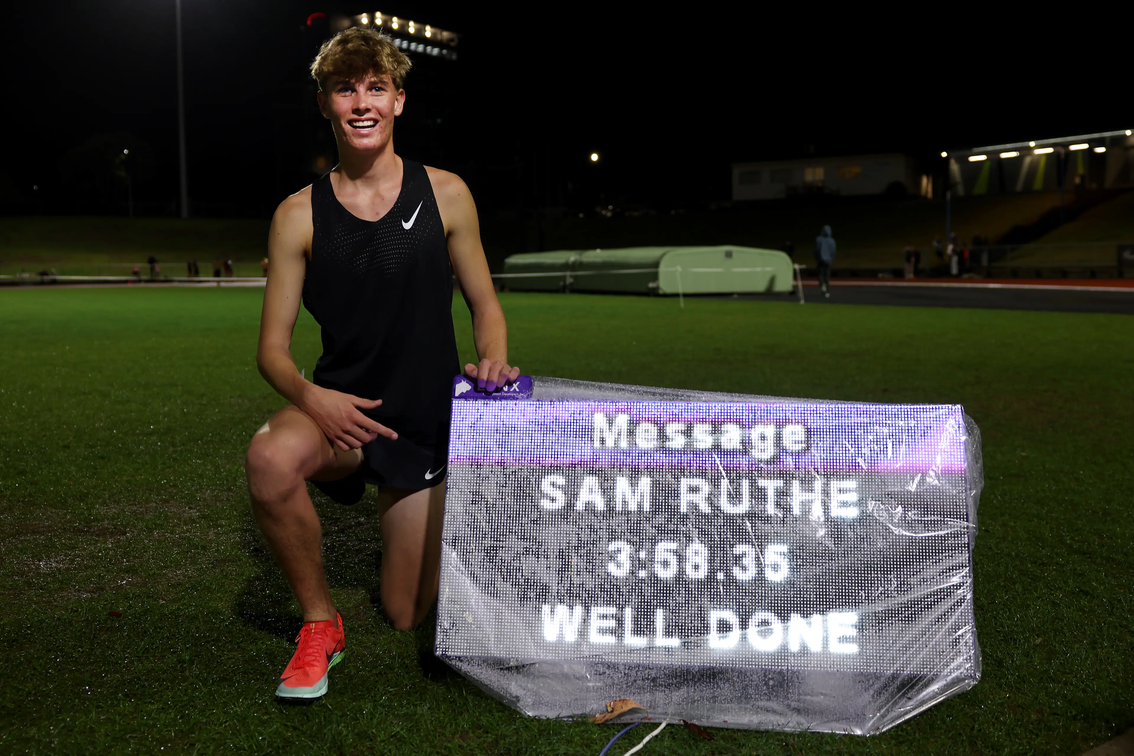 New Zealand middle distance runner Sam Ruthe poses with his time of 3:58.35. Image credit: Getty