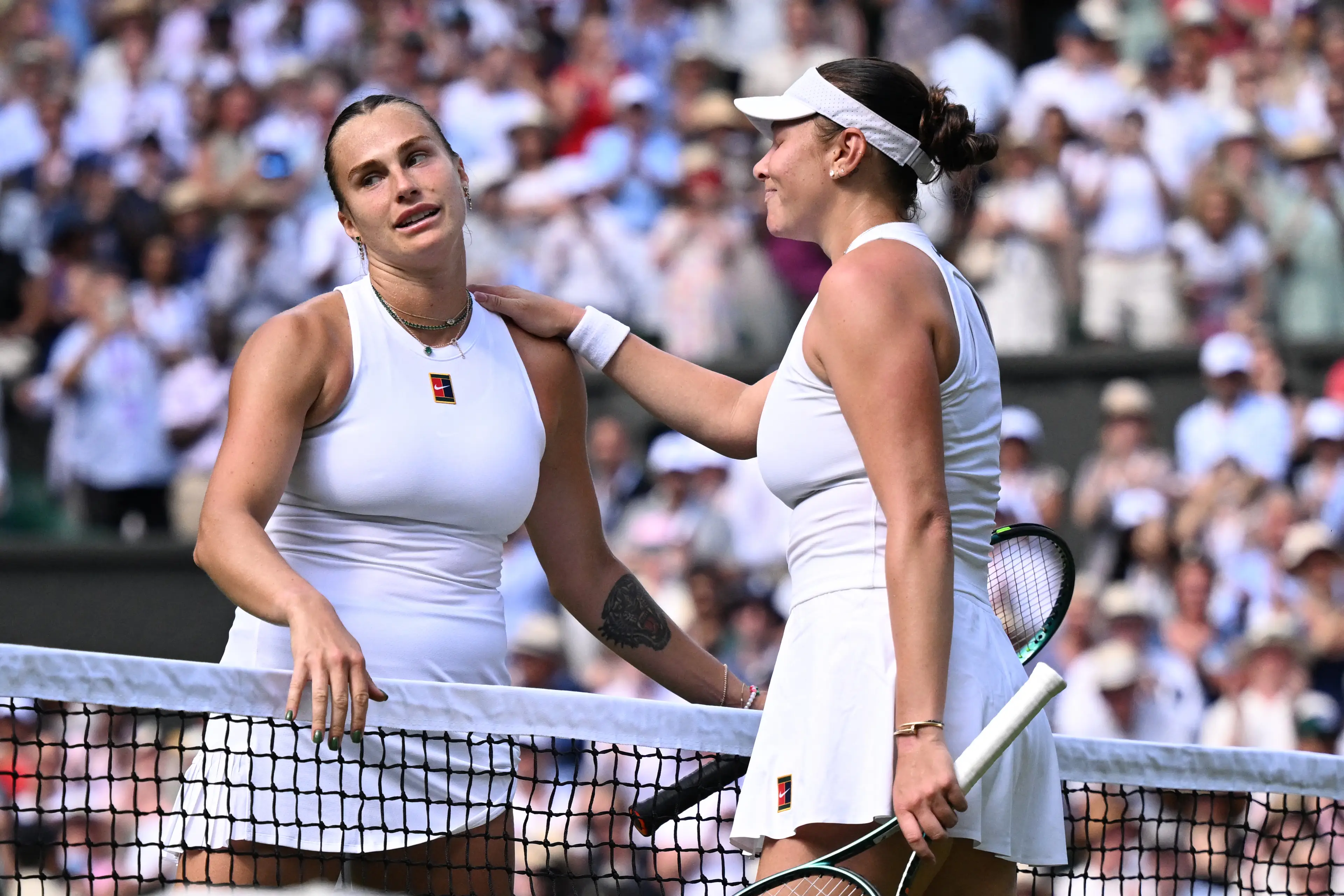 Aryna Sabalenka and Amanda Anisimova share an embrace after their battle at Wimbledon. Image: Getty 