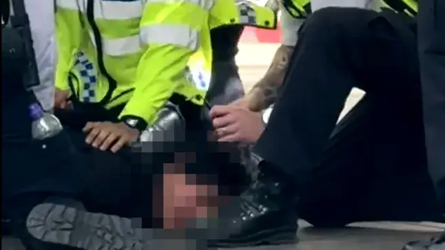 The boy was tackled to the ground by police. Image credit: The Sun
